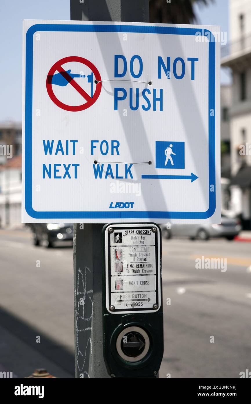 A pedestrian push button at a traffic signal at a crosswalk at the ...