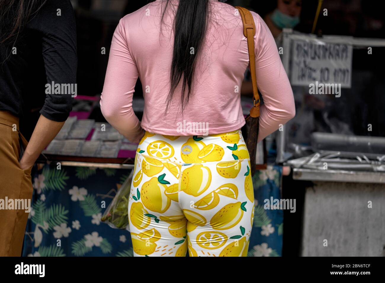 Leggings. Woman wearing colourful yellow patterned leggings. Thailand Southeast Asia Stock Photo