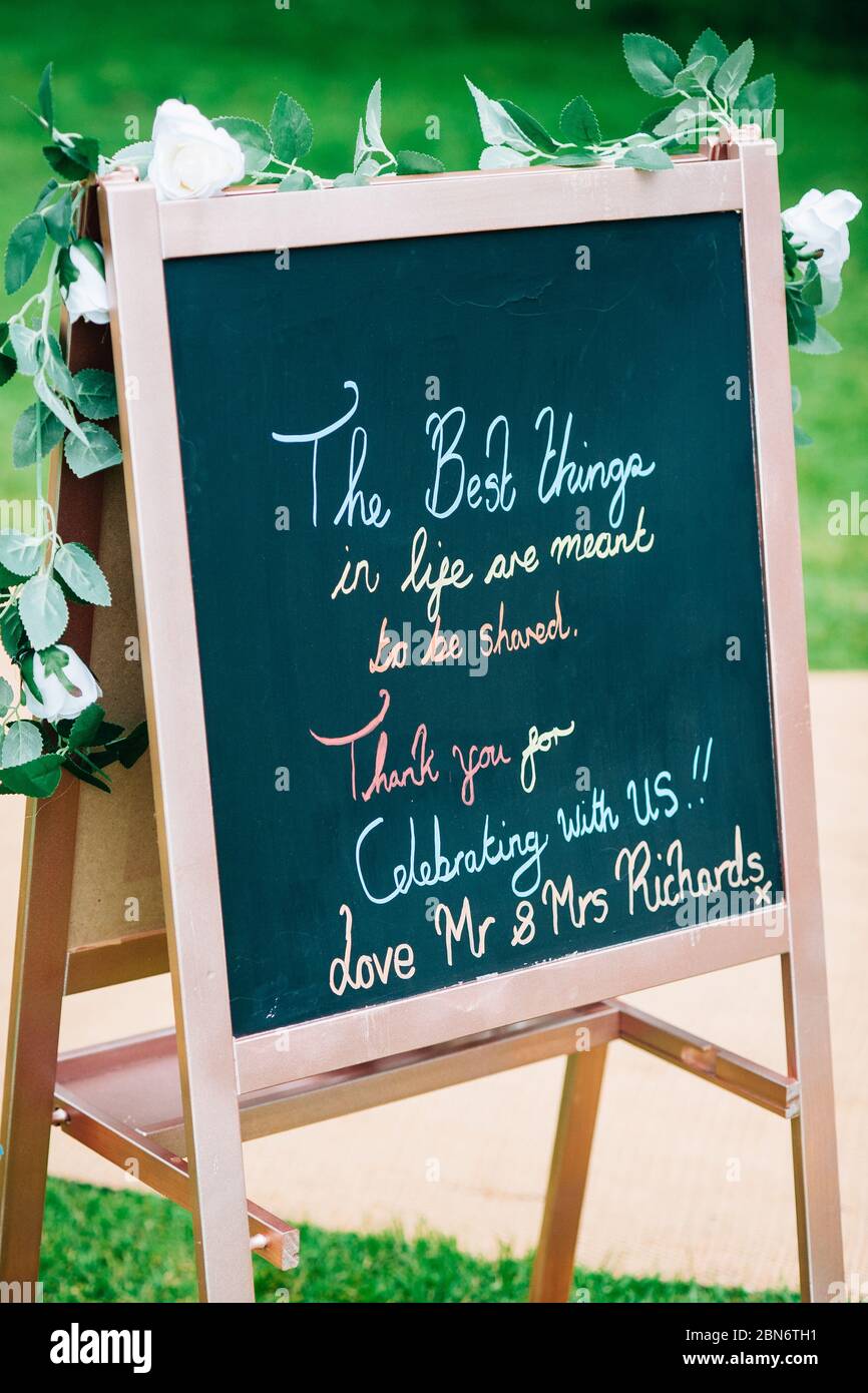 rustic boho wooden blackboard sign UK England outdoor wedding ceremony Stock Photo
