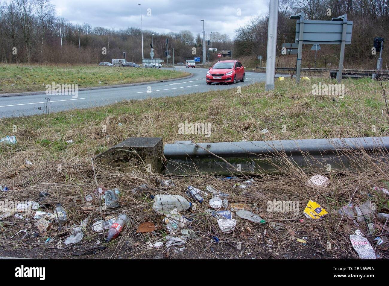 Rubbish on a roadside, thrown out of cars. Wigan, Lancashire, UK Stock