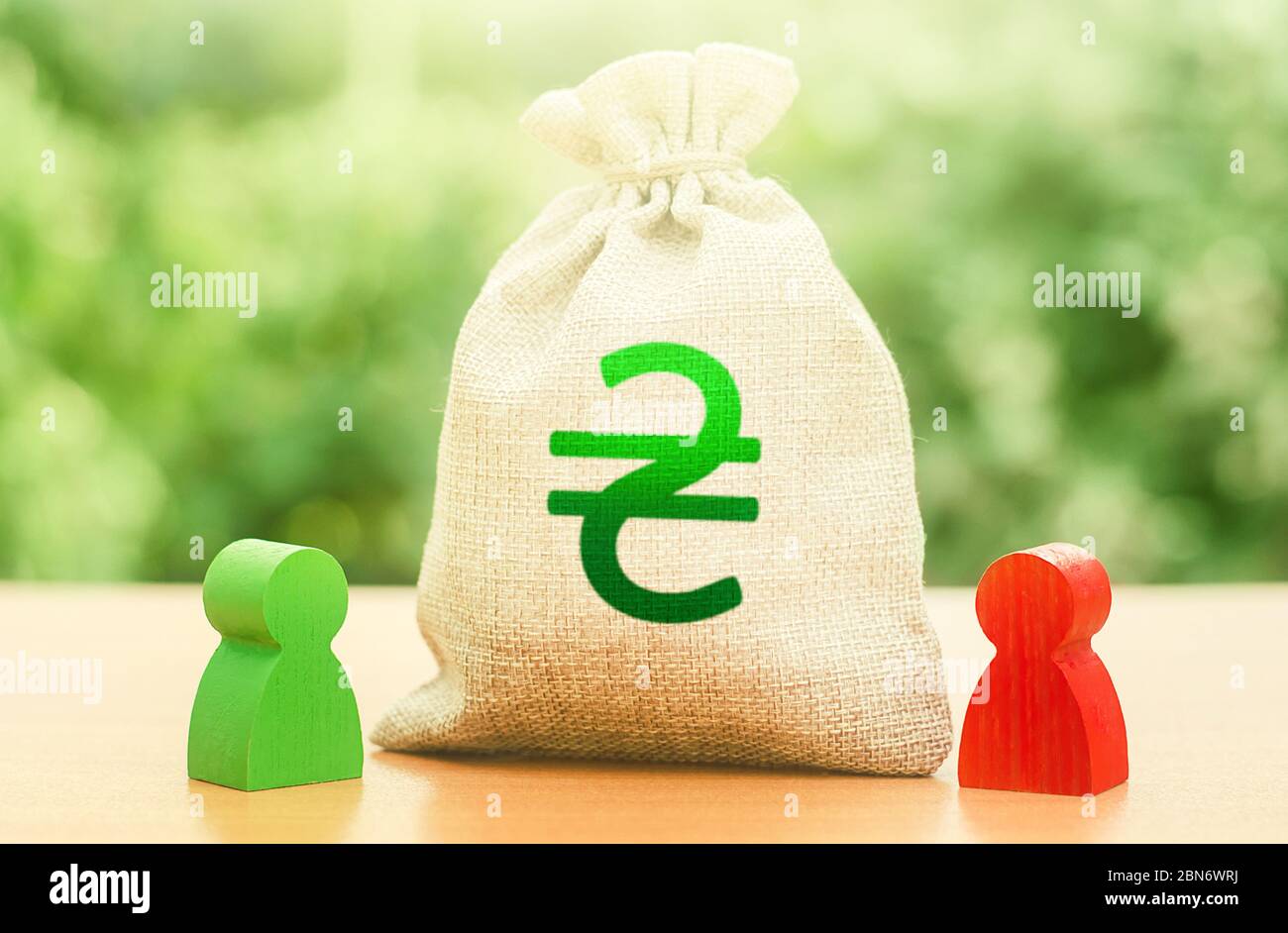 Ukrainian hryvnia money bag and a deal between two persons. Business lending. Negotiation process dealings. Dispute solution. Finance surety promise. Stock Photo