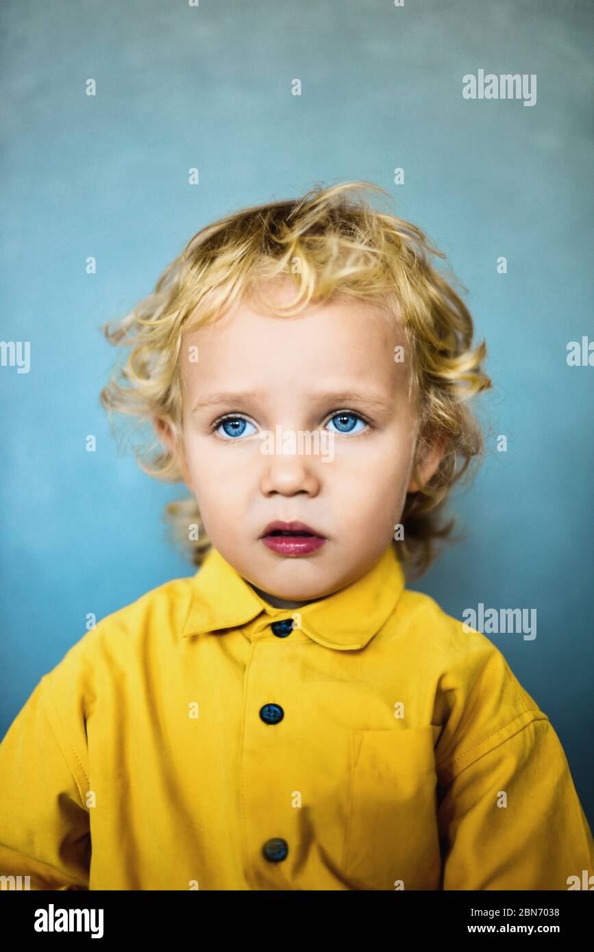 Adorable sweet little boy with golden hair and blue eyes Stock Photo - Alamy