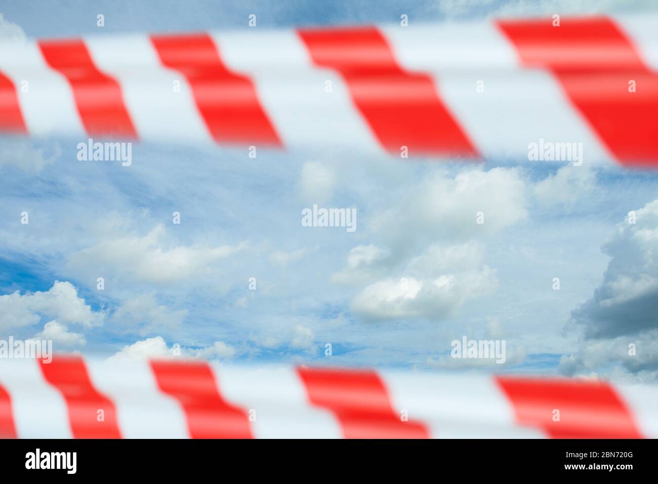 Quarantine, canceled flights and deferred vacation concept. Sky, clouds and red warning tape Stock Photo