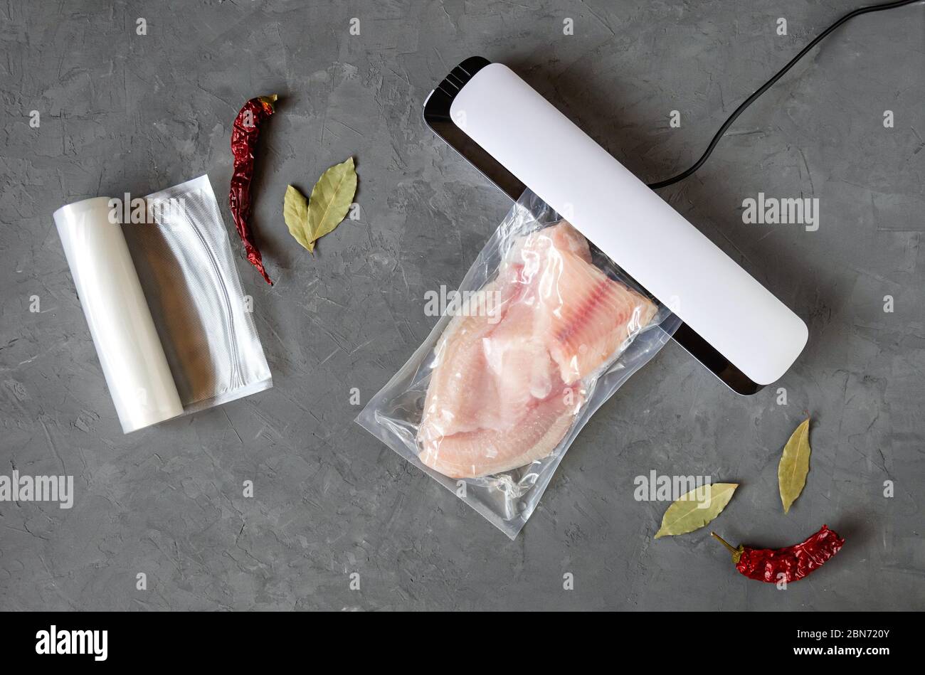 Tilapia fillet in a vacuum bag. Vacuum packaging of fish. The use of a