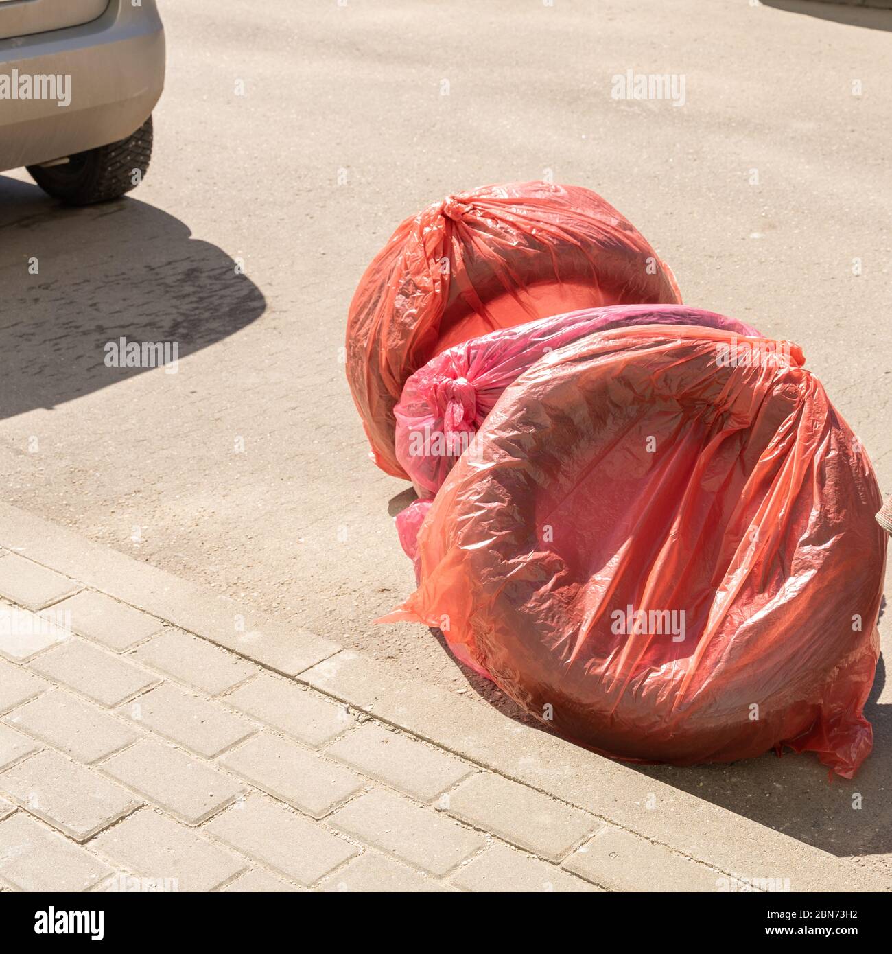 set of wheels. Wheels are packed in bags and lie near the car Stock Photo Alamy