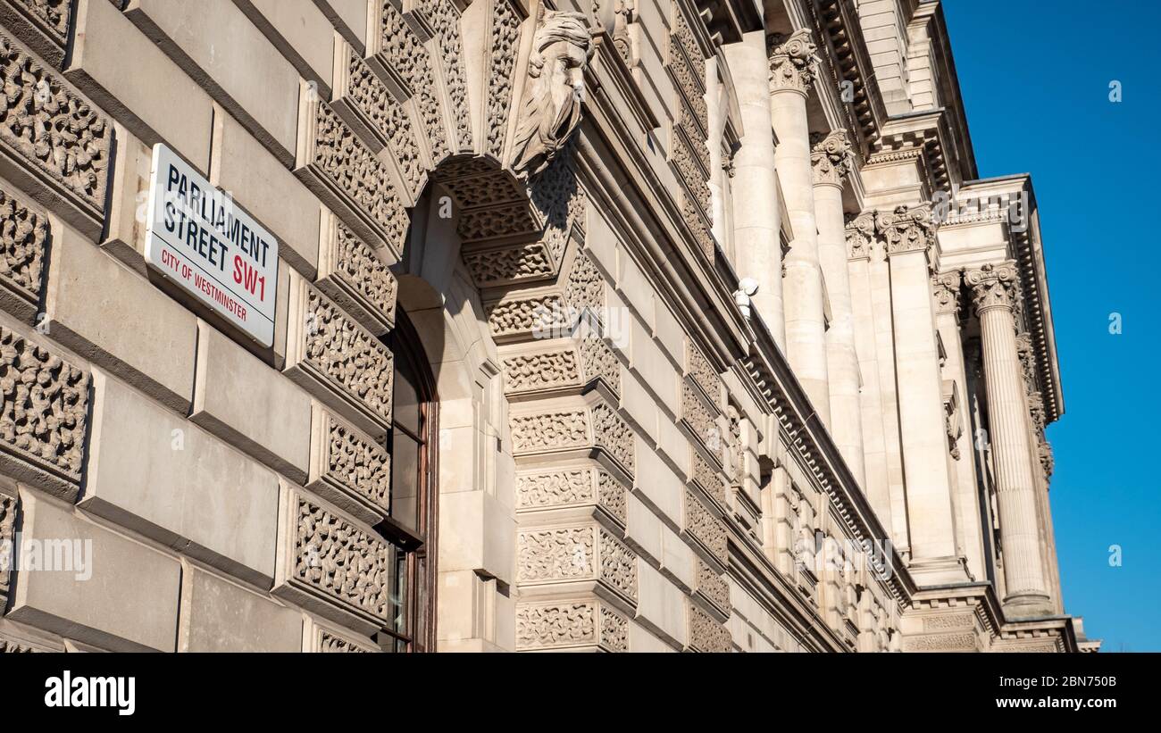 Parliament Street and Whitehall are  synonymous with UK government.  The street sign is attached to HM Treasury, known as The Exchequer. Stock Photo