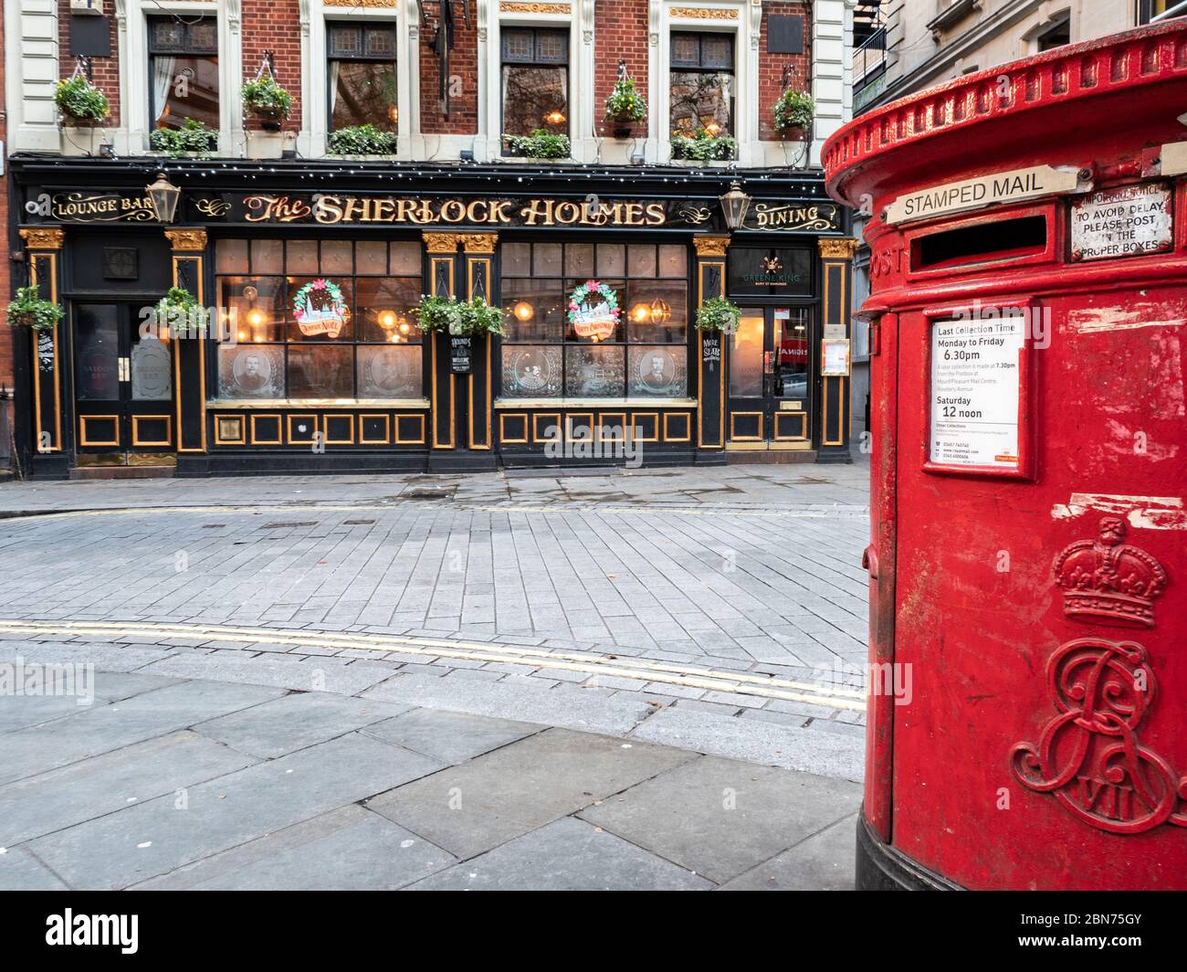 London Street Scene An Old Red Post Box Outside A Traditional English Pub The Sherlock Holmes In Westminster Christmas Decorations Visible Stock Photo Alamy