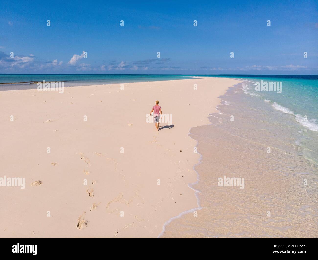 Traveller on Zanzibar. Empty beach at Snow-white sand bank of Nakupenda Island. Appearing just a few hours in a day. Aerial drone shot Stock Photo