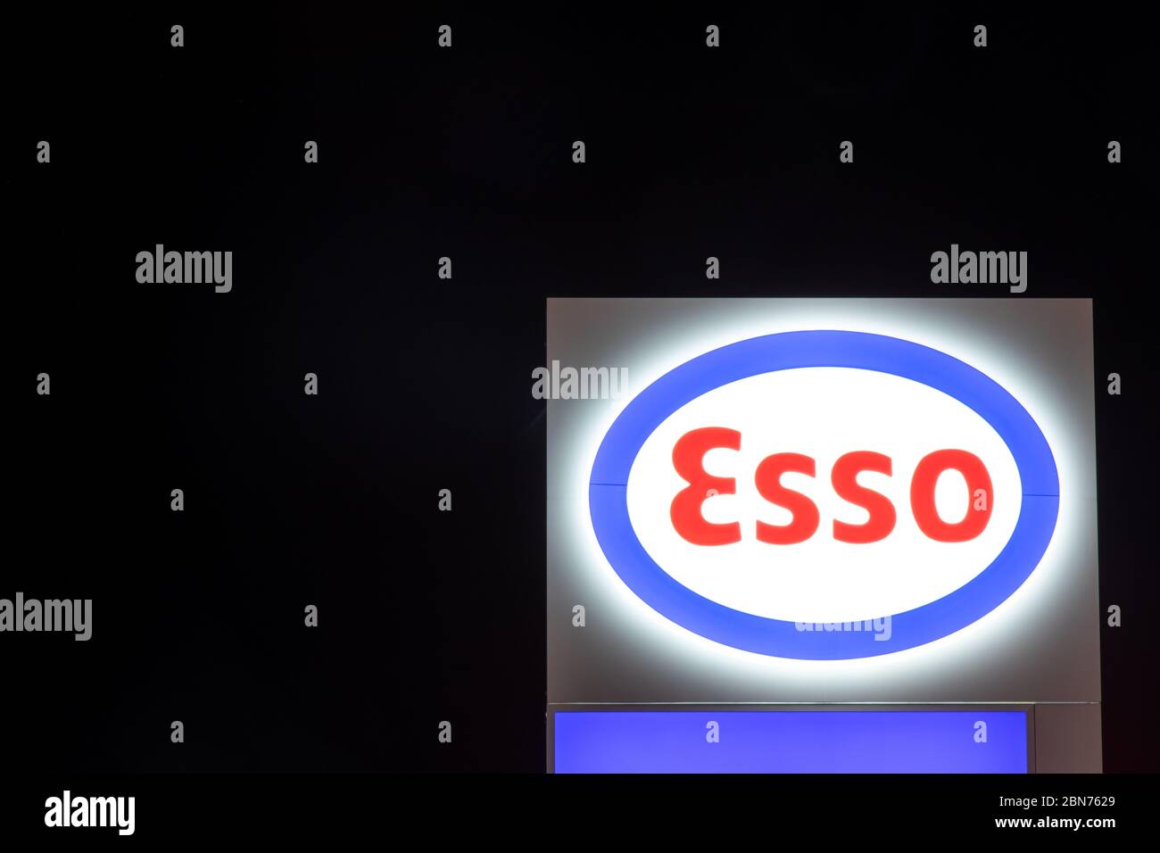 Esso logo, a trading name of ExxonMobil seen at night atop of a gas station sign near Toronto Pearson. Stock Photo