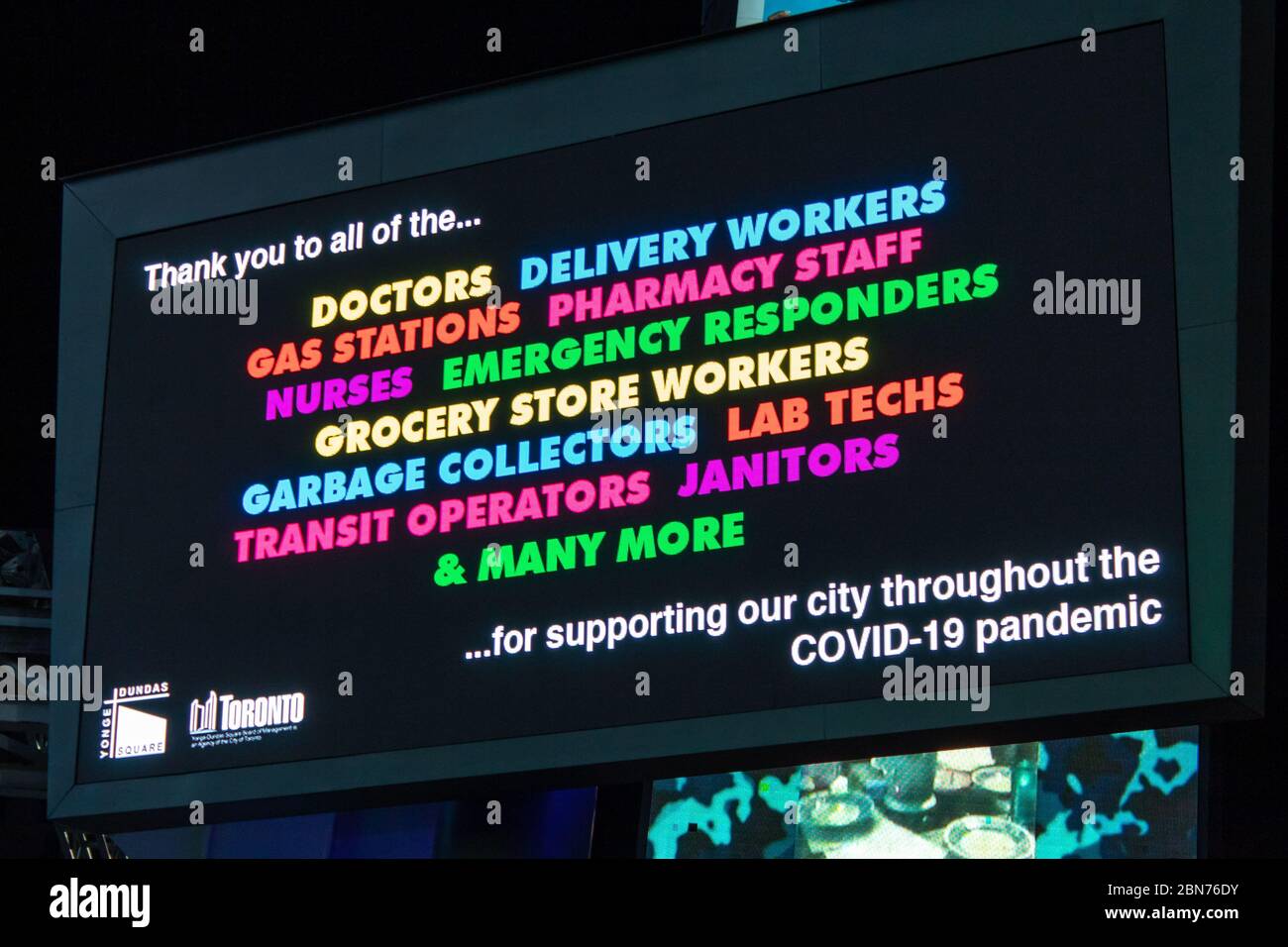 Sign thanking all essential workers on the frontlines helping to fight the coronavirus (COVID-19) pandemic. Sign in Young-Dundas Square Toronto. Stock Photo