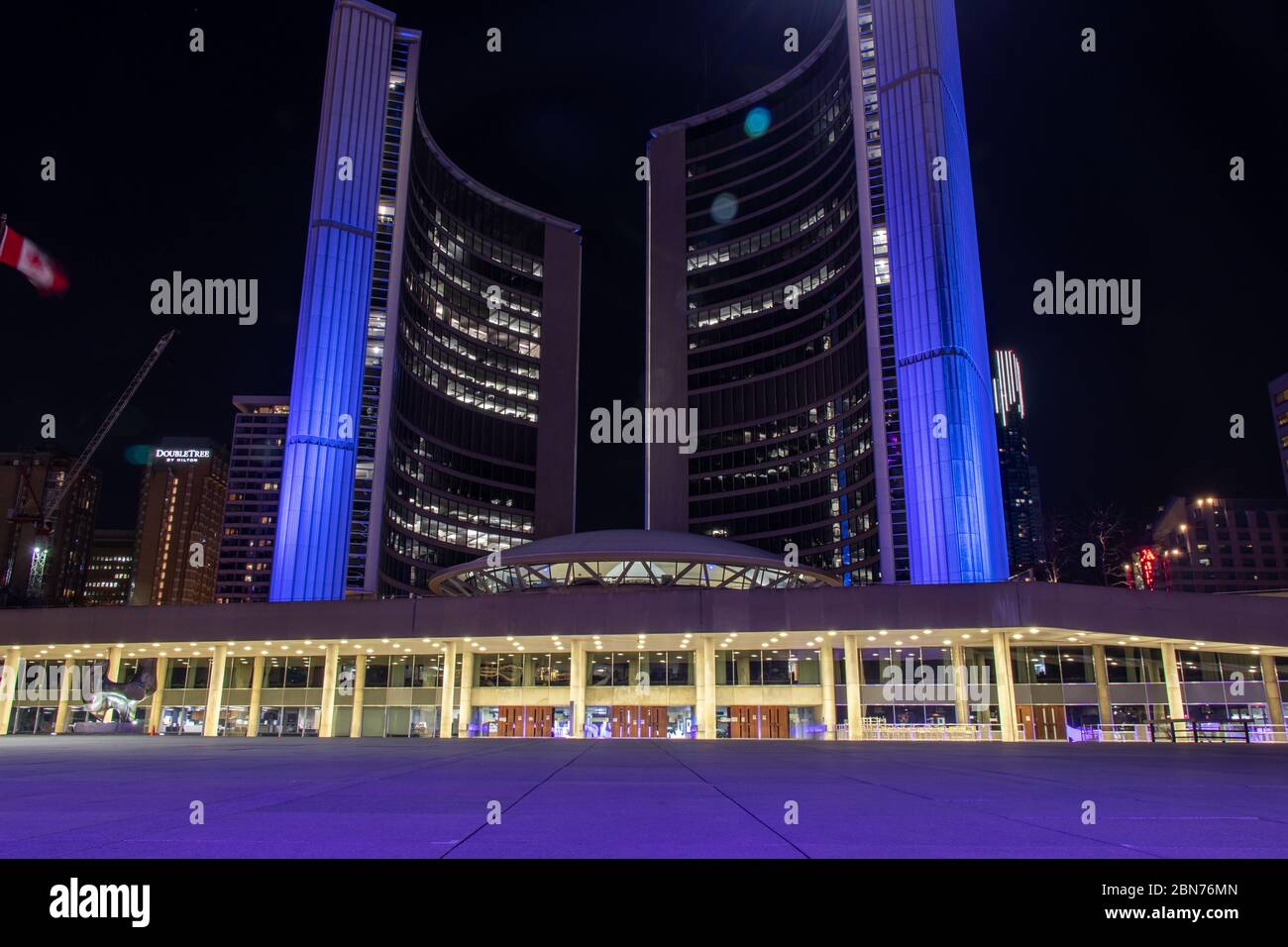 Toronto City Hall seen in purple, in support of hospitality workers fighting the COVID-19 ￼disease, the global coronavirus pandemic. Stock Photo