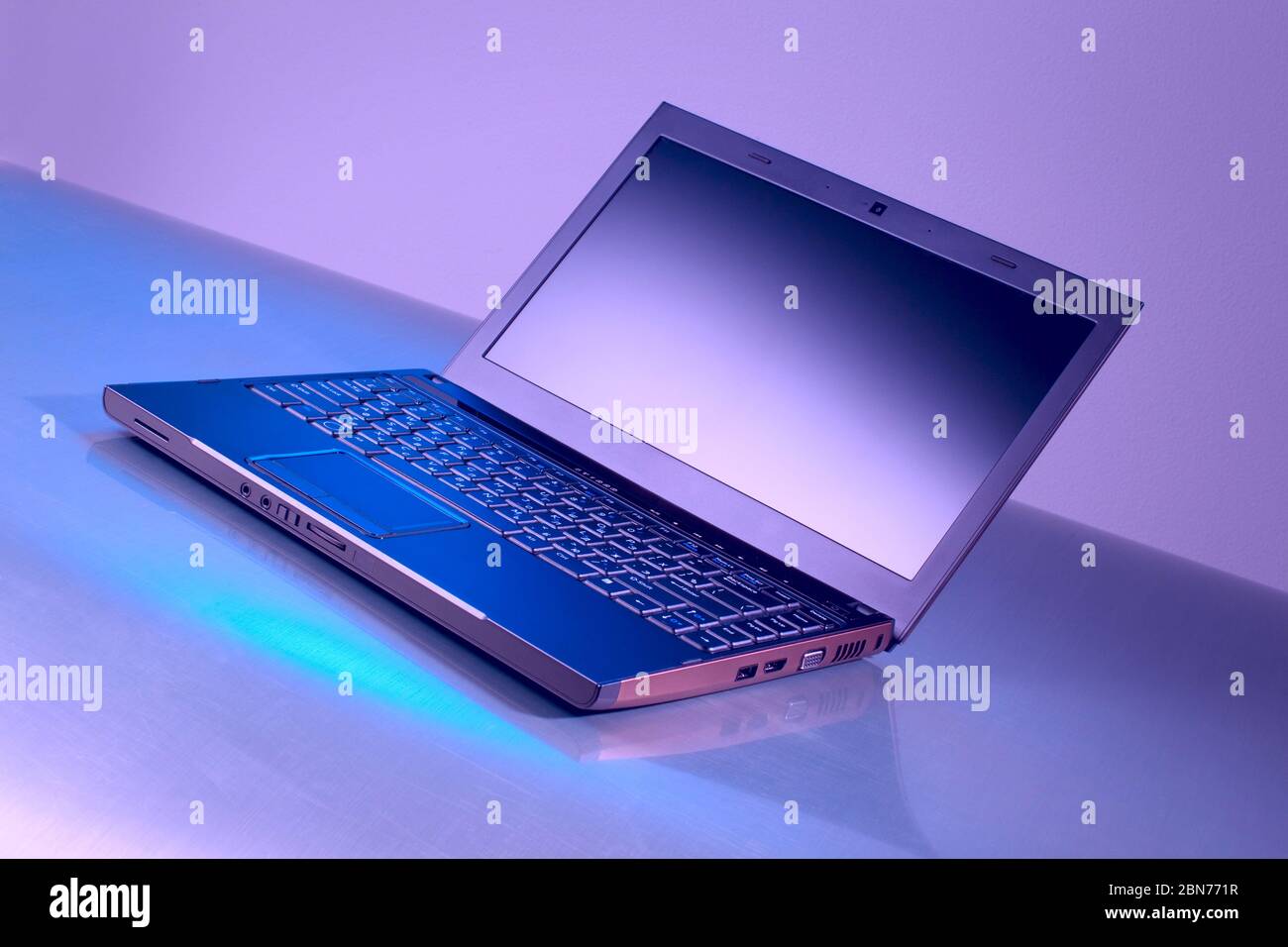 laptop on a crimson background with reflection Stock Photo - Alamy