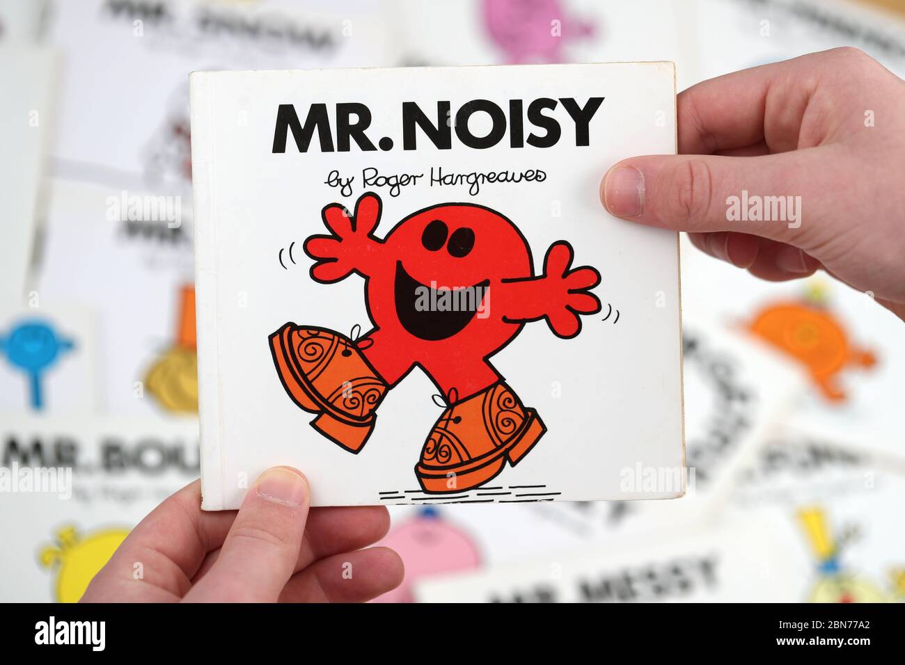 A boy about to read the Mr Men book, Mr Noisy by Roger Hargreaves Stock Photo