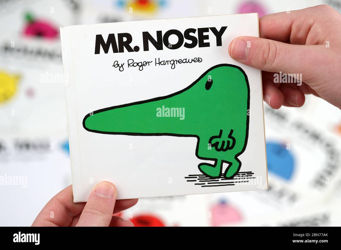 A boy about to read the Mr Men book, Mr Nosey by Roger Hargreaves Stock Photo