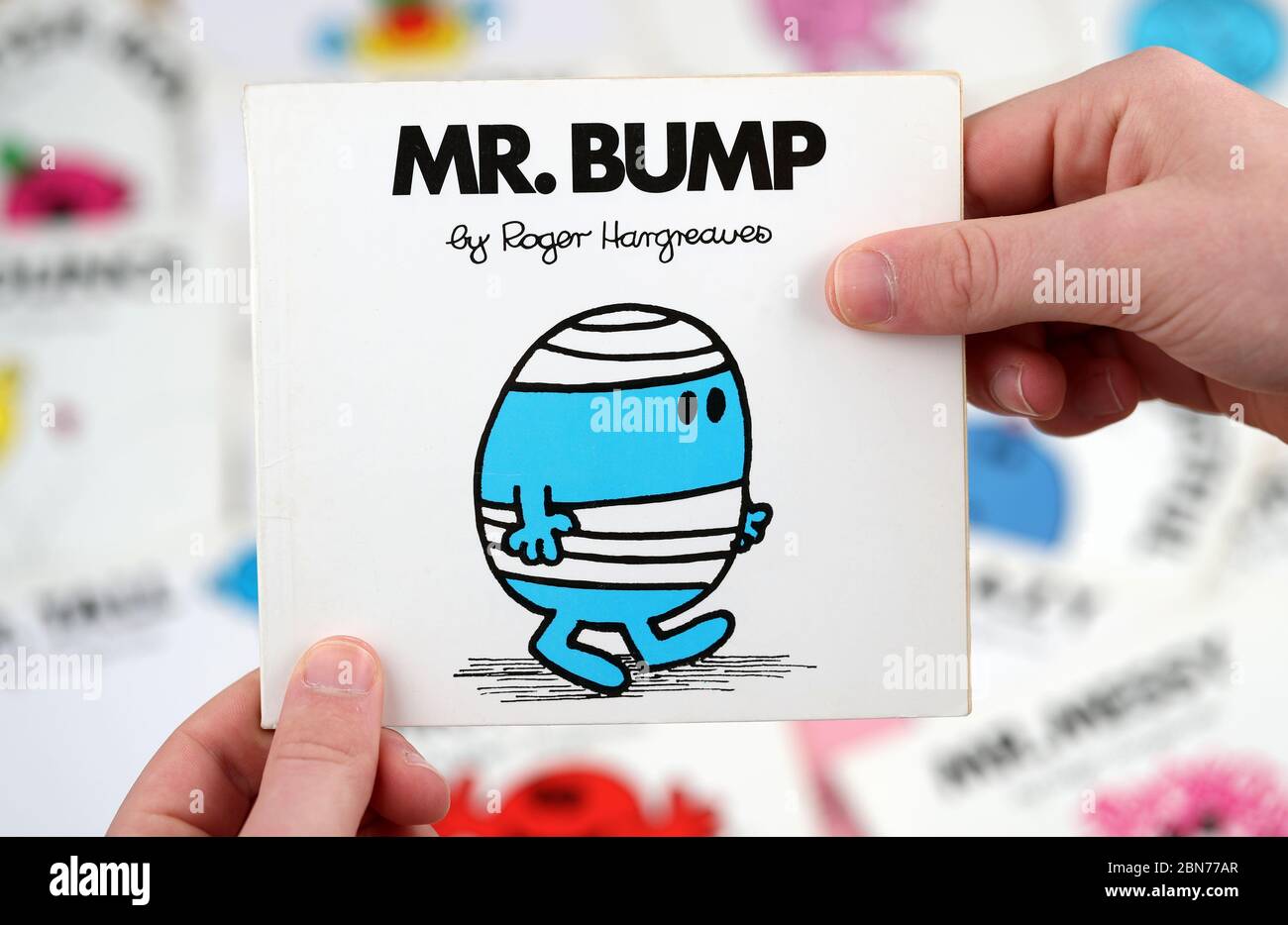 A boy about to read the Mr Men book, Mr Bump by Roger Hargreaves Stock Photo