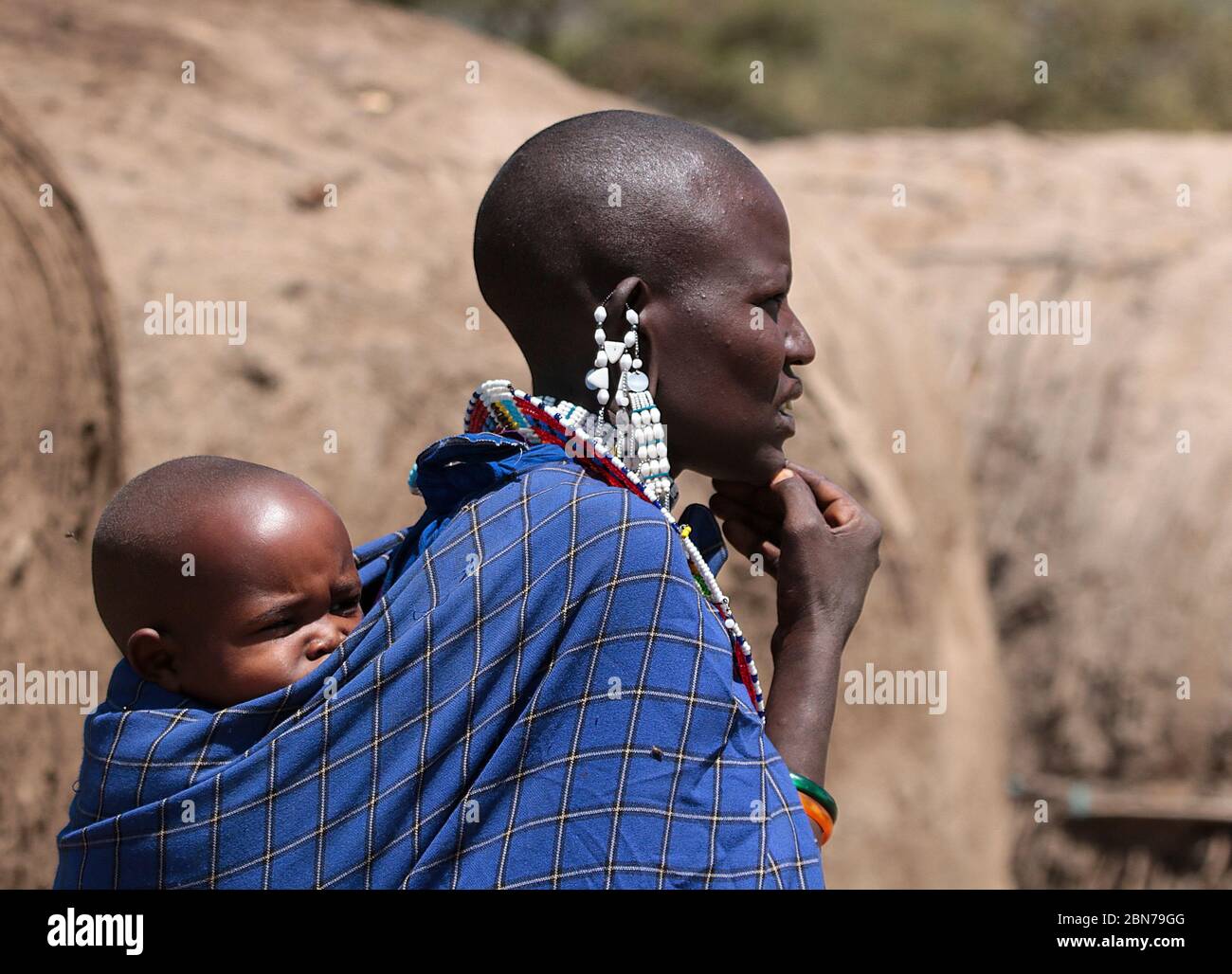 Maasai Woman with her baby. Maasai is an ethnic group of semi-nomadic people. Photographed in Tanzania Stock Photo