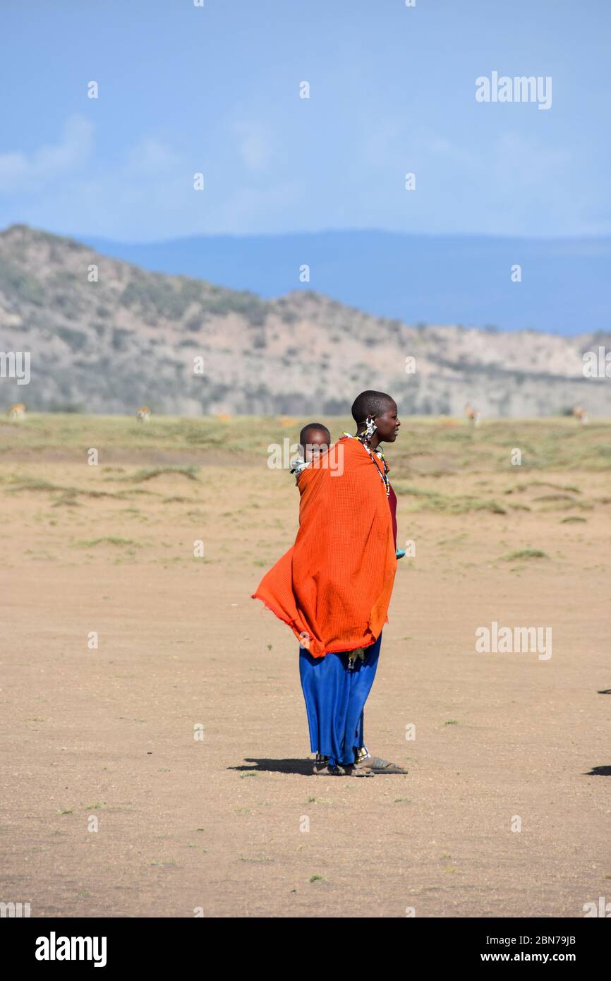 Maasai Woman with her baby. Maasai is an ethnic group of semi-nomadic people. Photographed in Tanzania Stock Photo