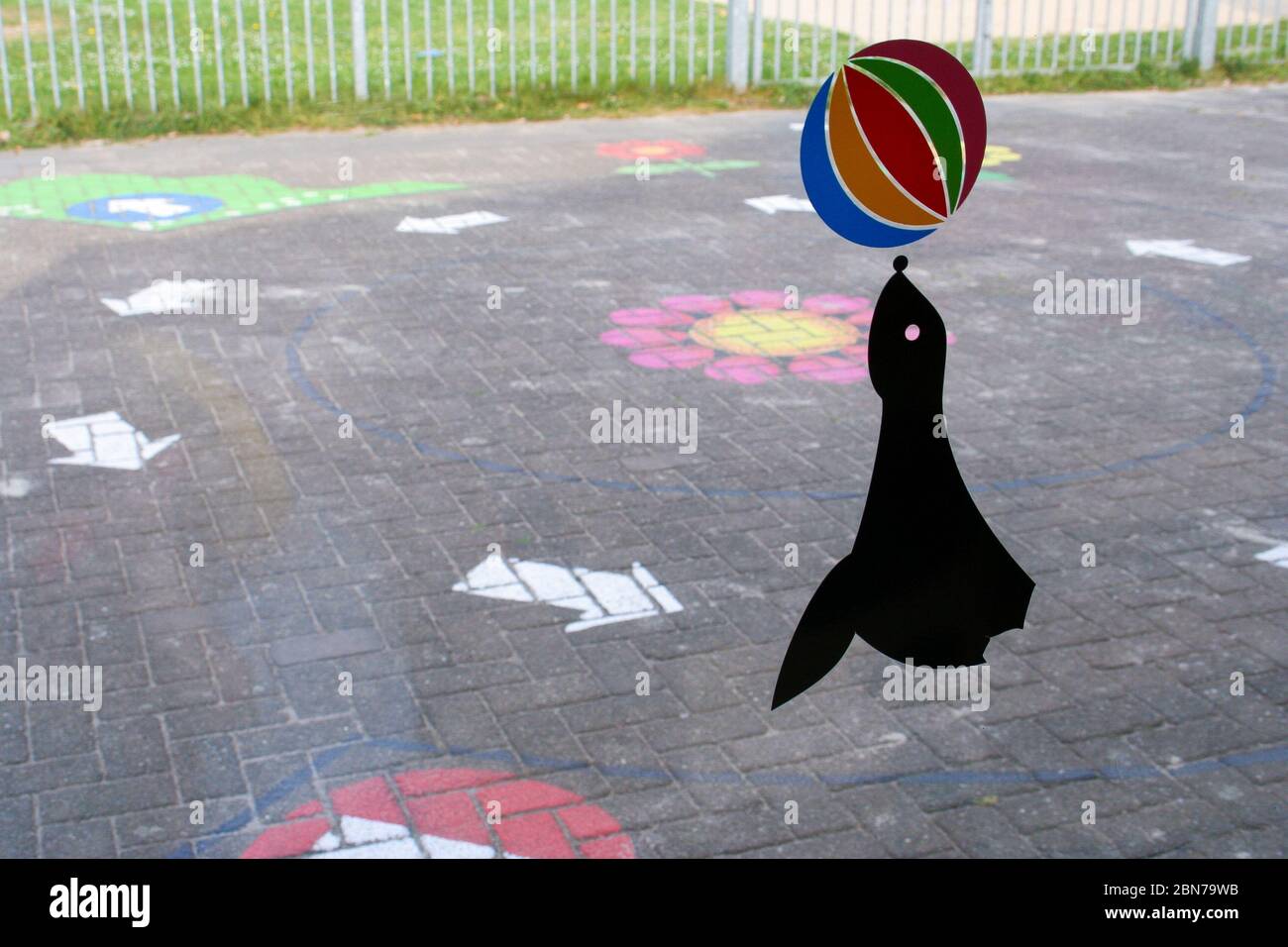 Sticker of a Seal with a Ball on the Window of a Childcare Center, Outside Sidewalk Chalk Drawings to See Stock Photo
