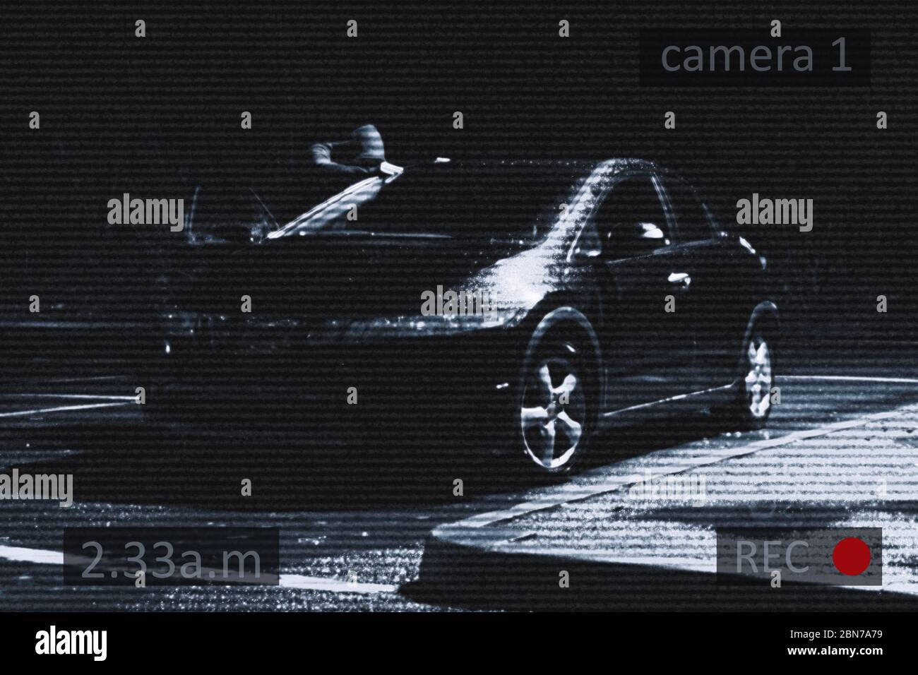 A car parked underneath a street light, with a hooded figure looking