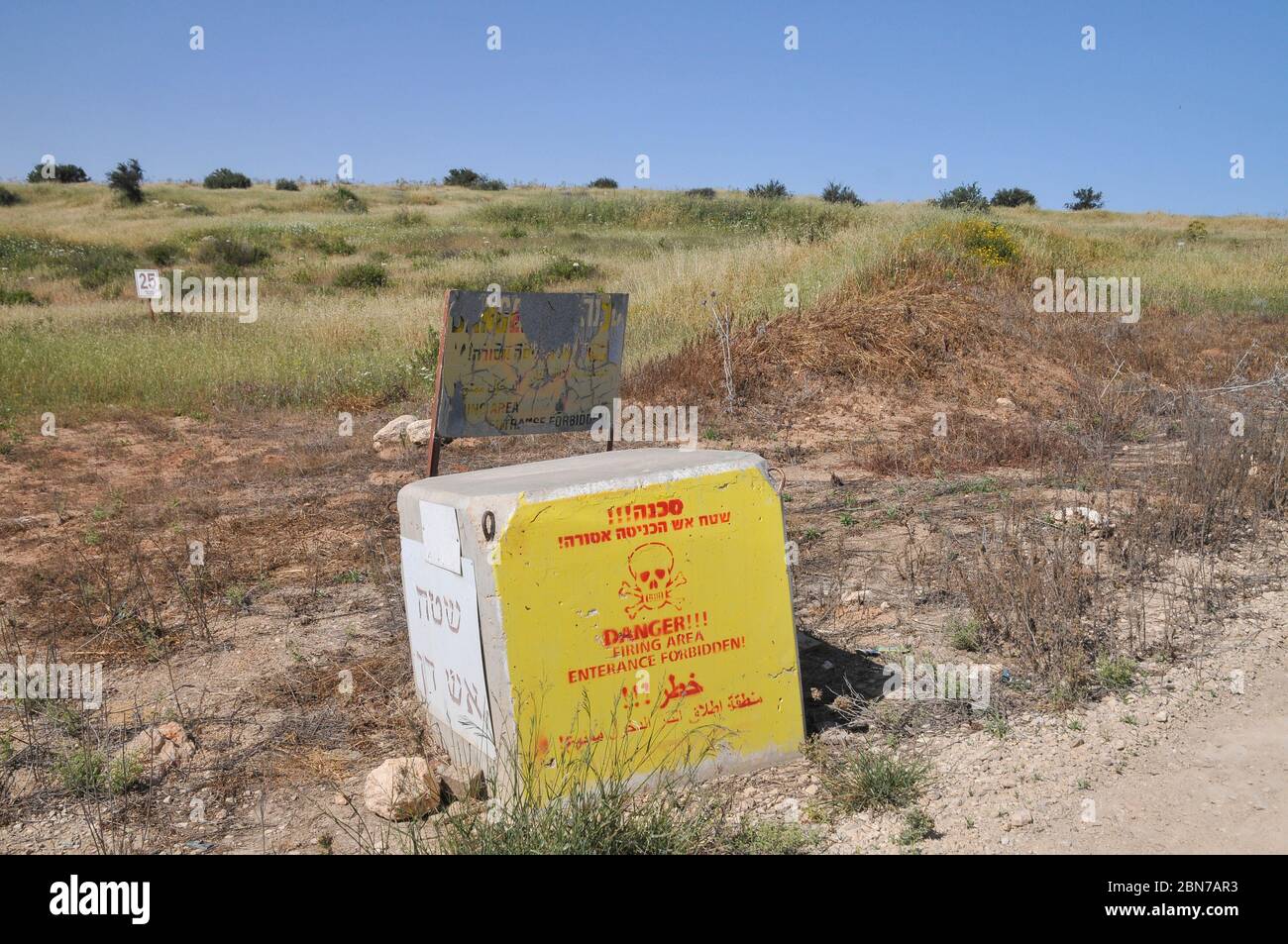A warning sign at the entrance to a military shooting range Photographed in the Northern Negev desert, Israel Stock Photo