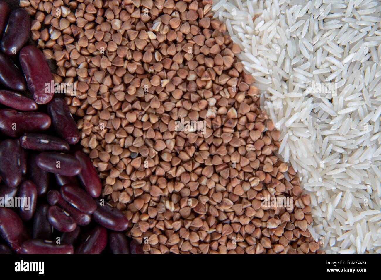 Raw Rice Beans Raw rice, buckwheat and beans are laid out in strips as a backdrop ...
