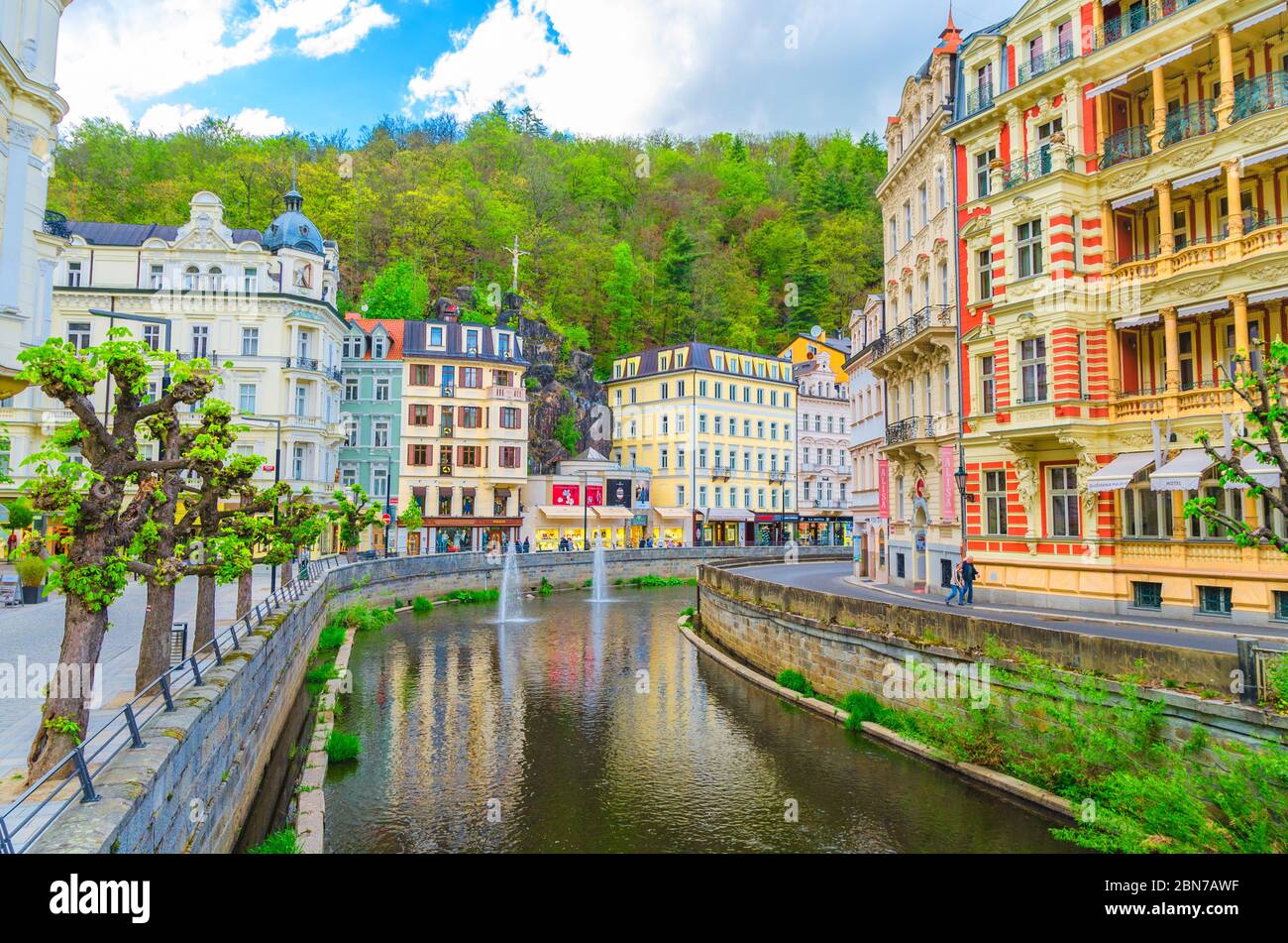 Karlovy Vary, Czech Republic, May 10, 2019: people are walking down street and Tepla river embankment in Carlsbad historical city centre with colorful Stock Photo