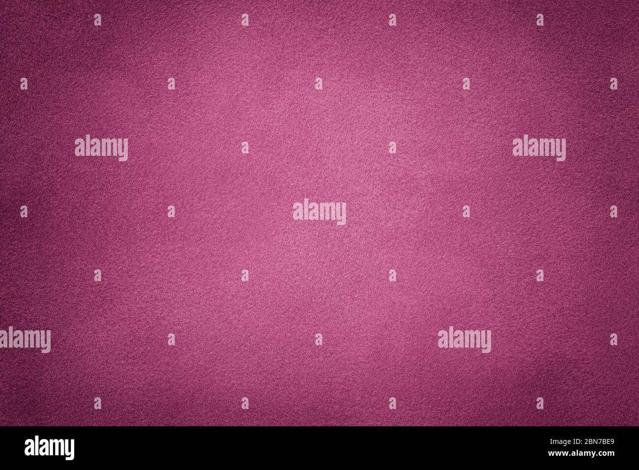 Background of dark purple suede fabric closeup. Velvet matt texture of