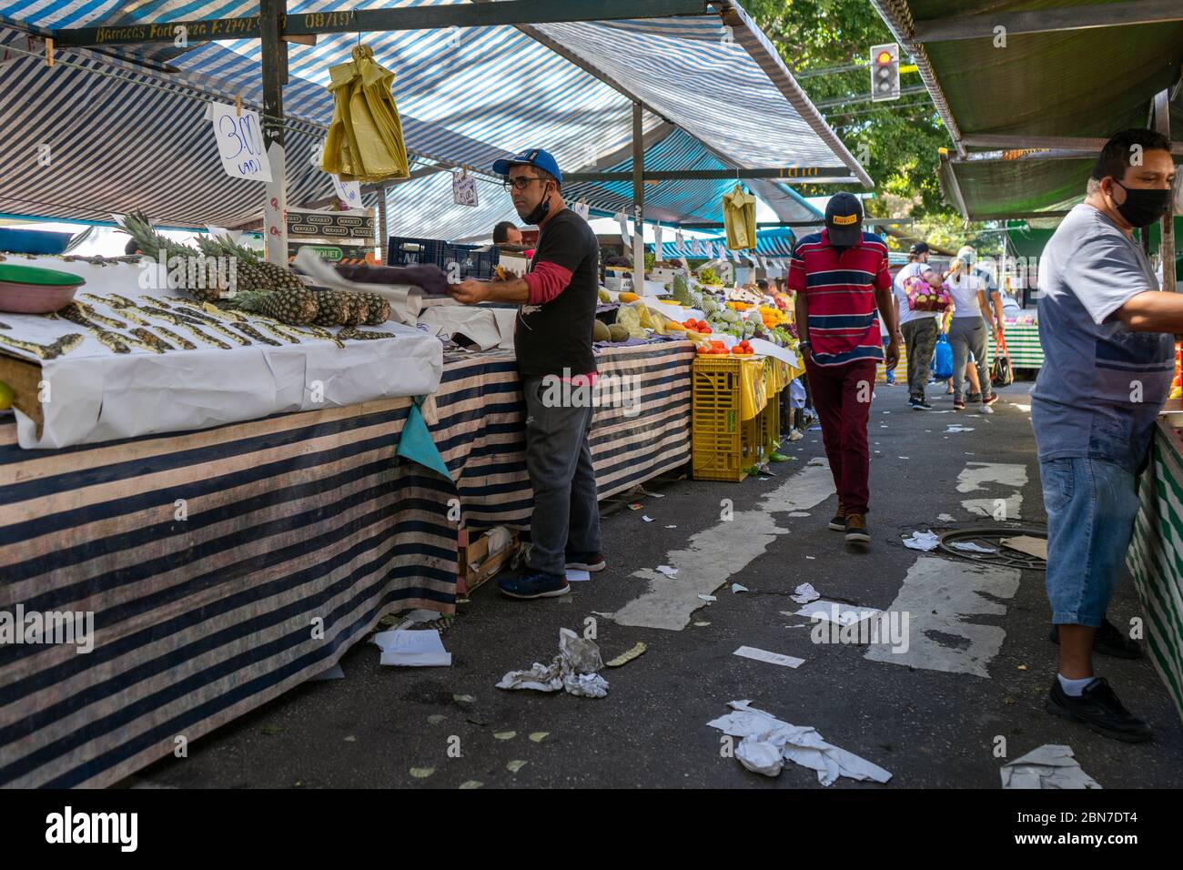 Open air street market in Sao Paulo, Brazil, during the COVID19 corona crisis in May 2020. Most shoppers are using mask but not social distancing Stock Photo