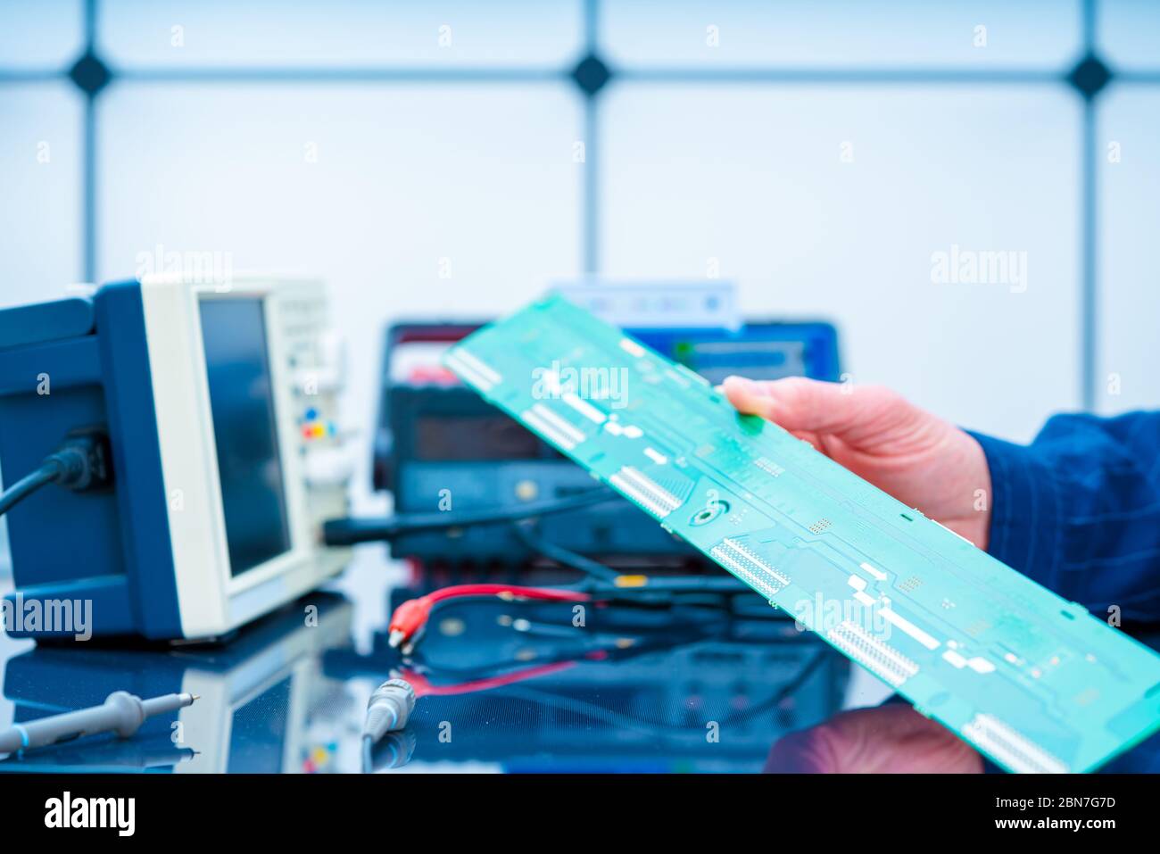 Debugging electronics device. PCB witch microcontroller in electronics laboratory Stock Photo