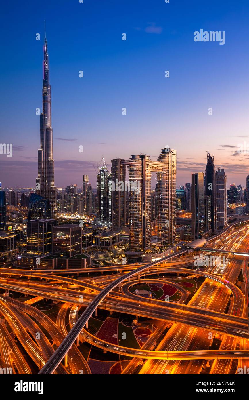 The view of the futuristic Dubai skyline and Sheikh Zaed road at dusk, UAE. Stock Photo