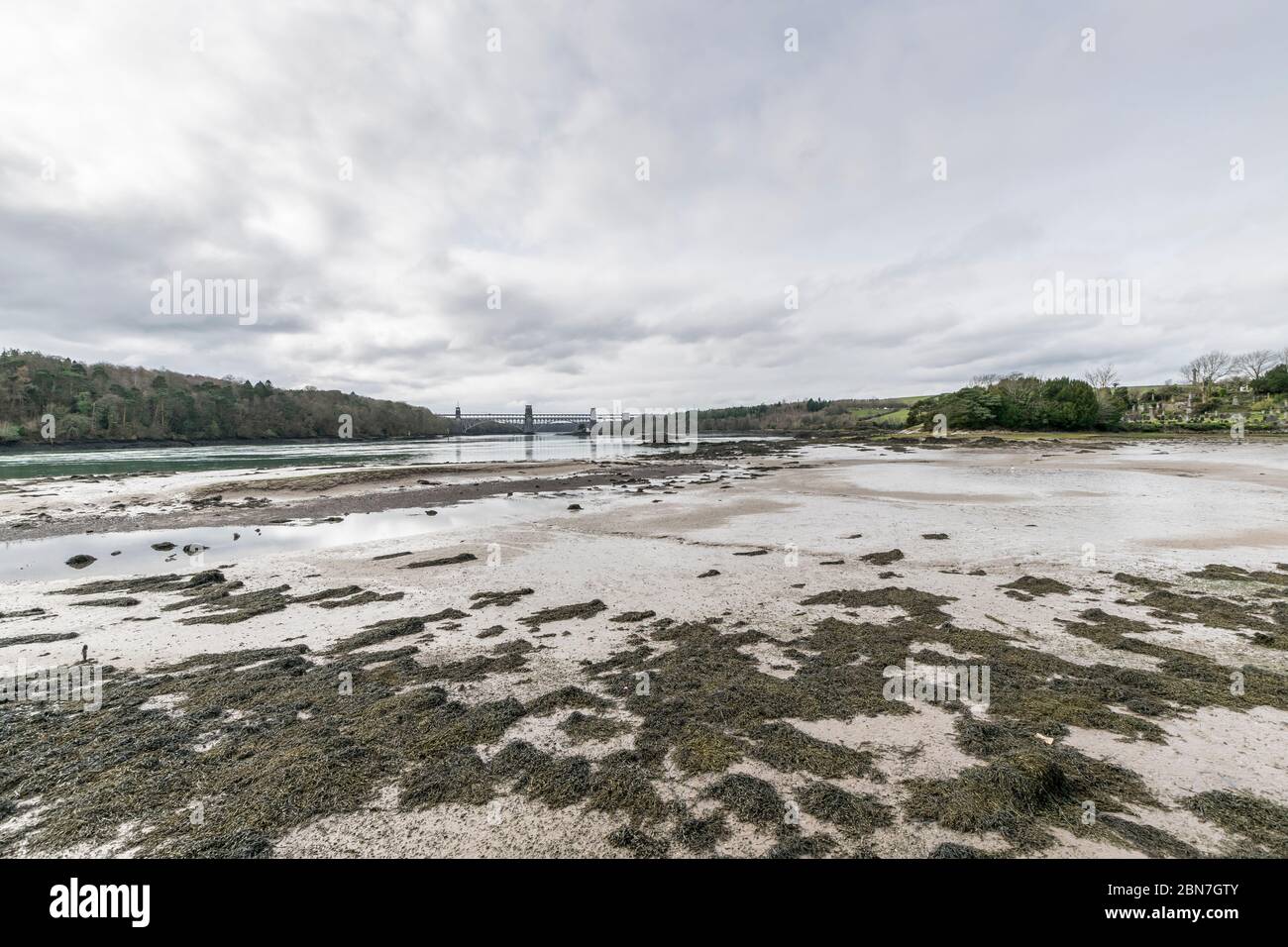 Church Island at Porthaethwy Anglesey in North Wales looking towards Pont Brittania on the Menai Straits from St Tysilio church graveyard Stock Photo