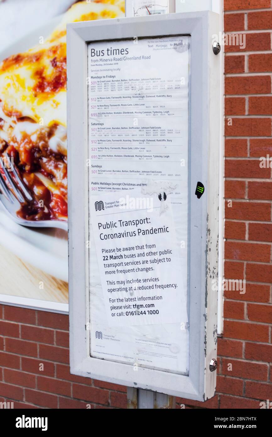 Notice about changes to GMPTE (Greater Manchester Passenger Transport Executive) bus timetables at a Bolton bus stop. The frequency and timing of most Stock Photo