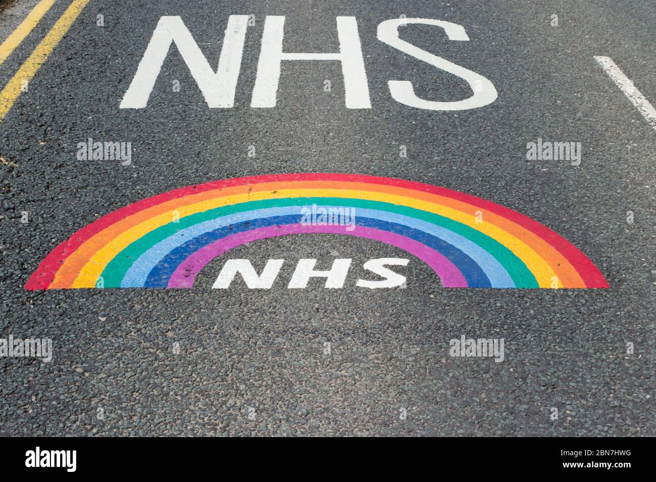 NHS rainbow message painted on the road, part of a 'Thank You NHS' message painted professionally on Minerva Raod, Bolton, on the approach to the Roya Stock Photo