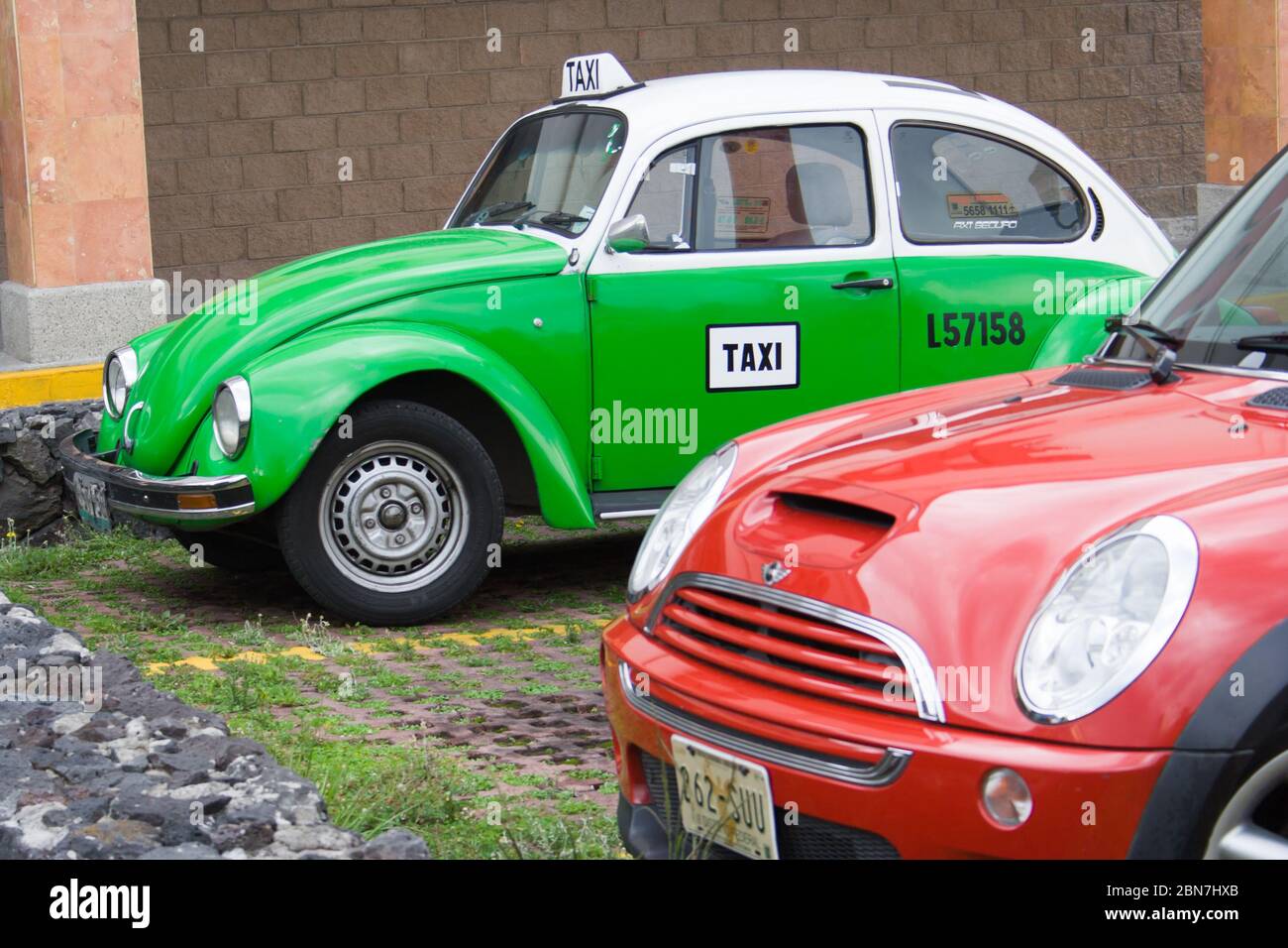 Mexican Green Taxi in a Parking Lot and a Red Car in Mexico City Stock