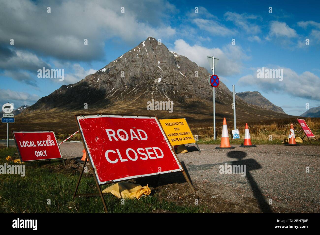 Closed roadsigns in Glencoe, due to Corona Virus pandemic lockdown. Road leading to Glen Etive with Buachaille Etive Mor, in background. Stock Photo
