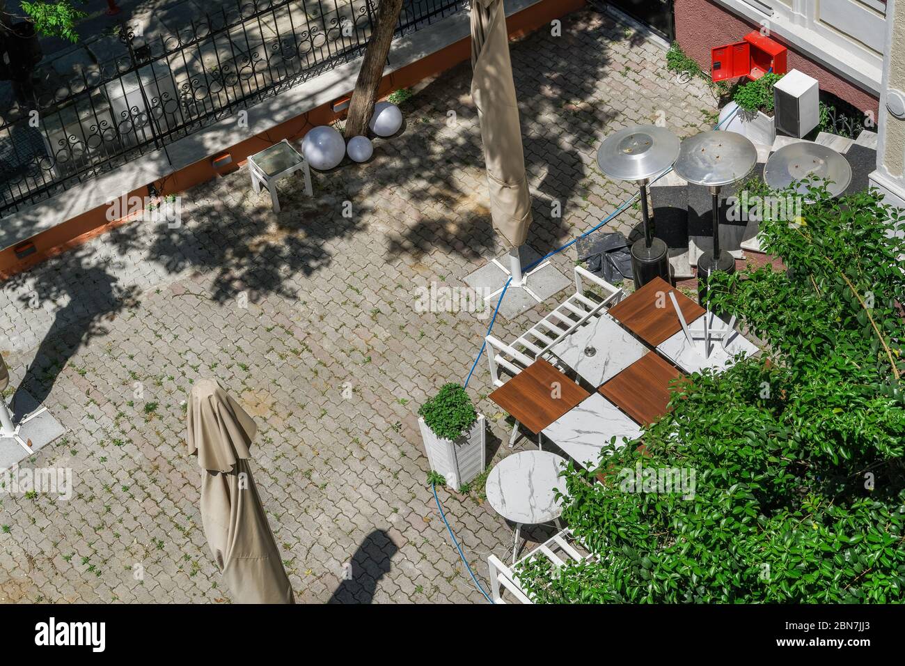 Empty outdoors tables as Coronavirus measures affect business. Thessaloniki, Greece bar restaurant closed after government tries to prevent COVID-19. Stock Photo