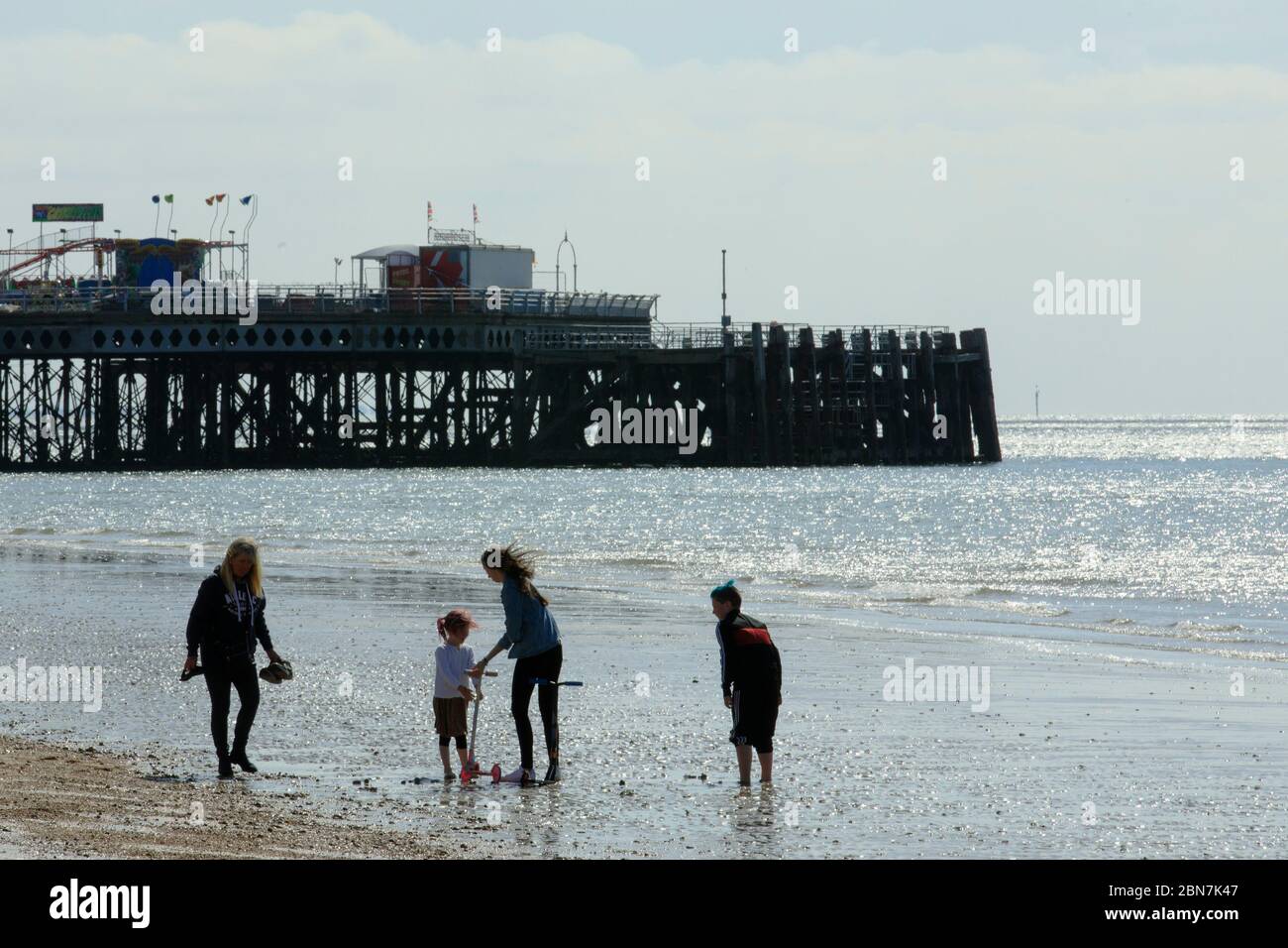 Portsmouth, UK. 13th May, 2020. A family paddle and play by the sea taking advantage of the new more relaxed lockdown rules, at Southsea, near Portsmouth, UK Wednesday May 12, 2020 Photograph Credit: Luke MacGregor/Alamy Live News Stock Photo