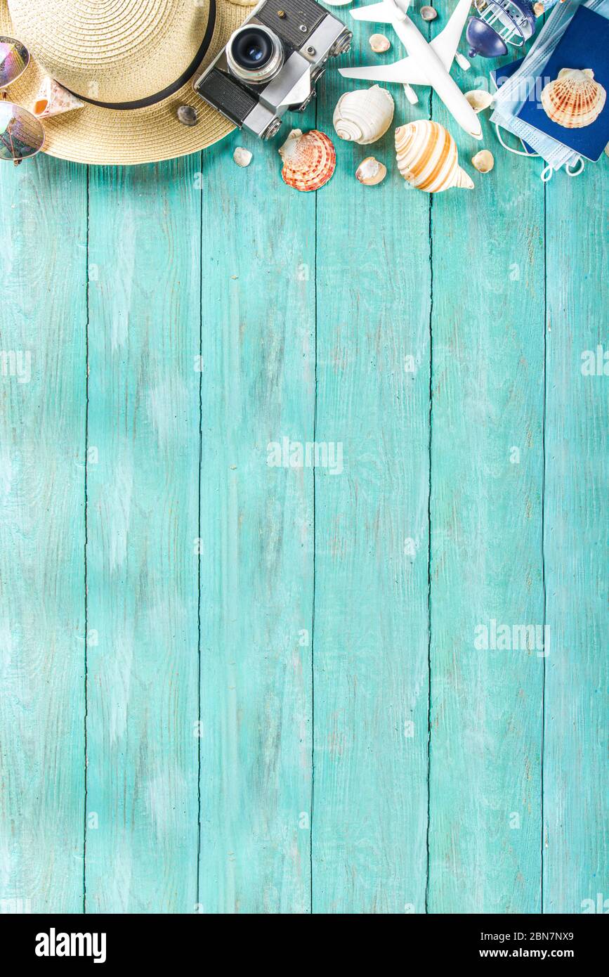 Bright summer flat-lay background. Old blue wooden background with with  summer woman clothes, sun glasses, hat, camera, passports and vacation  ticket Stock Photo - Alamy