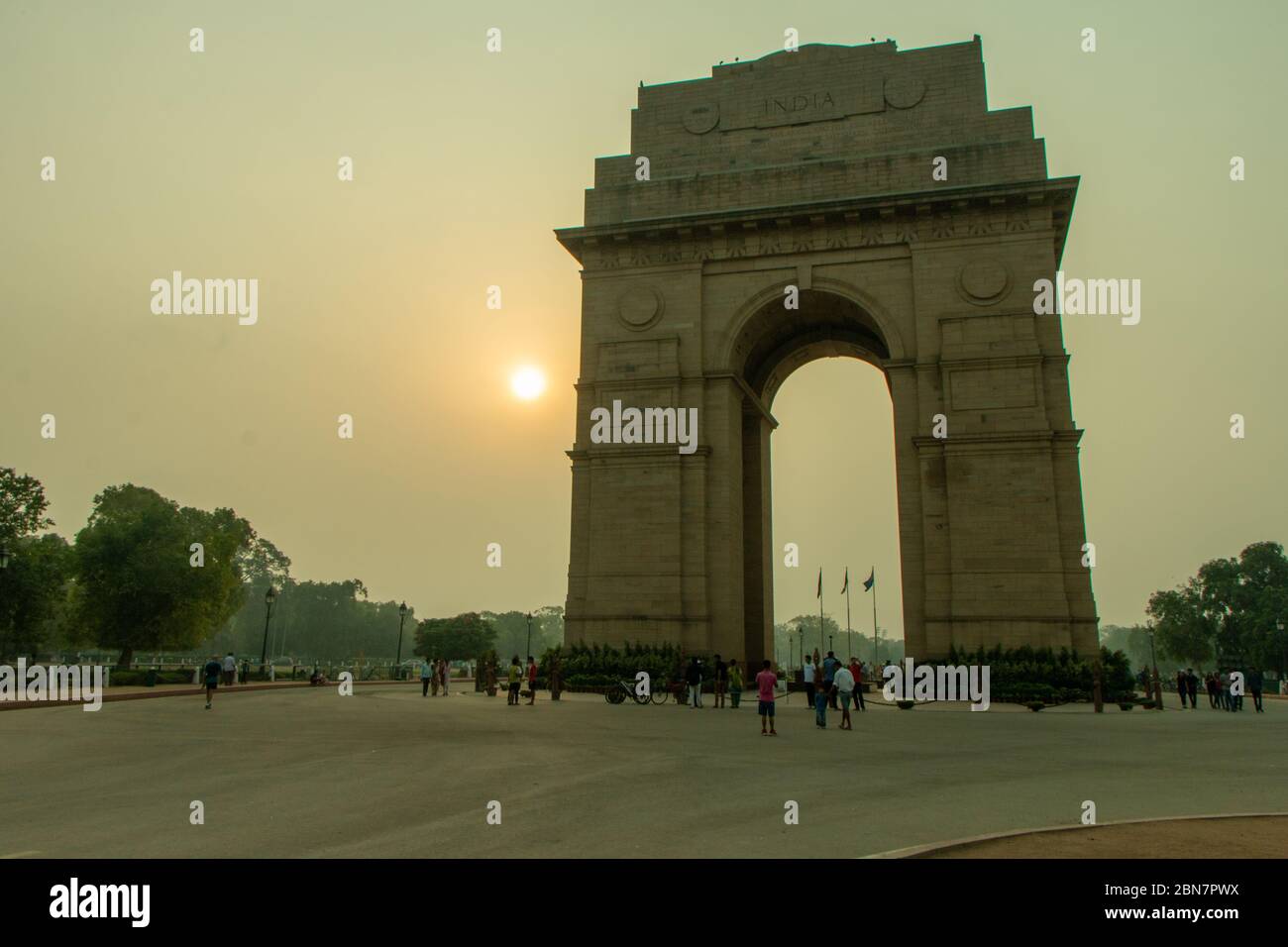 Wide shot of India Gate at sunrise with unrecognisable people Stock Photo