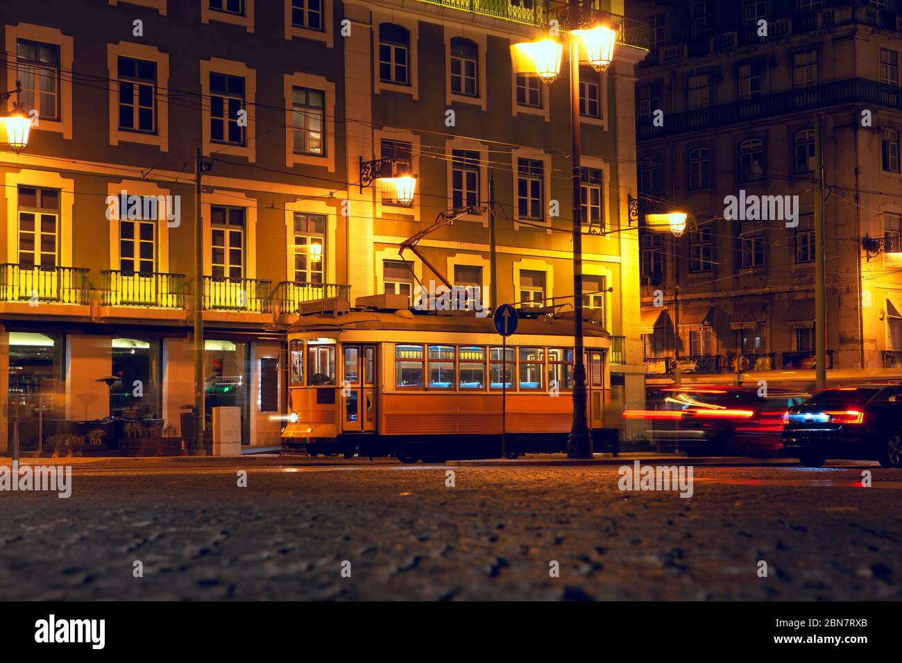 famous yellow tram at illuminated street in Lisbon Stock Photo