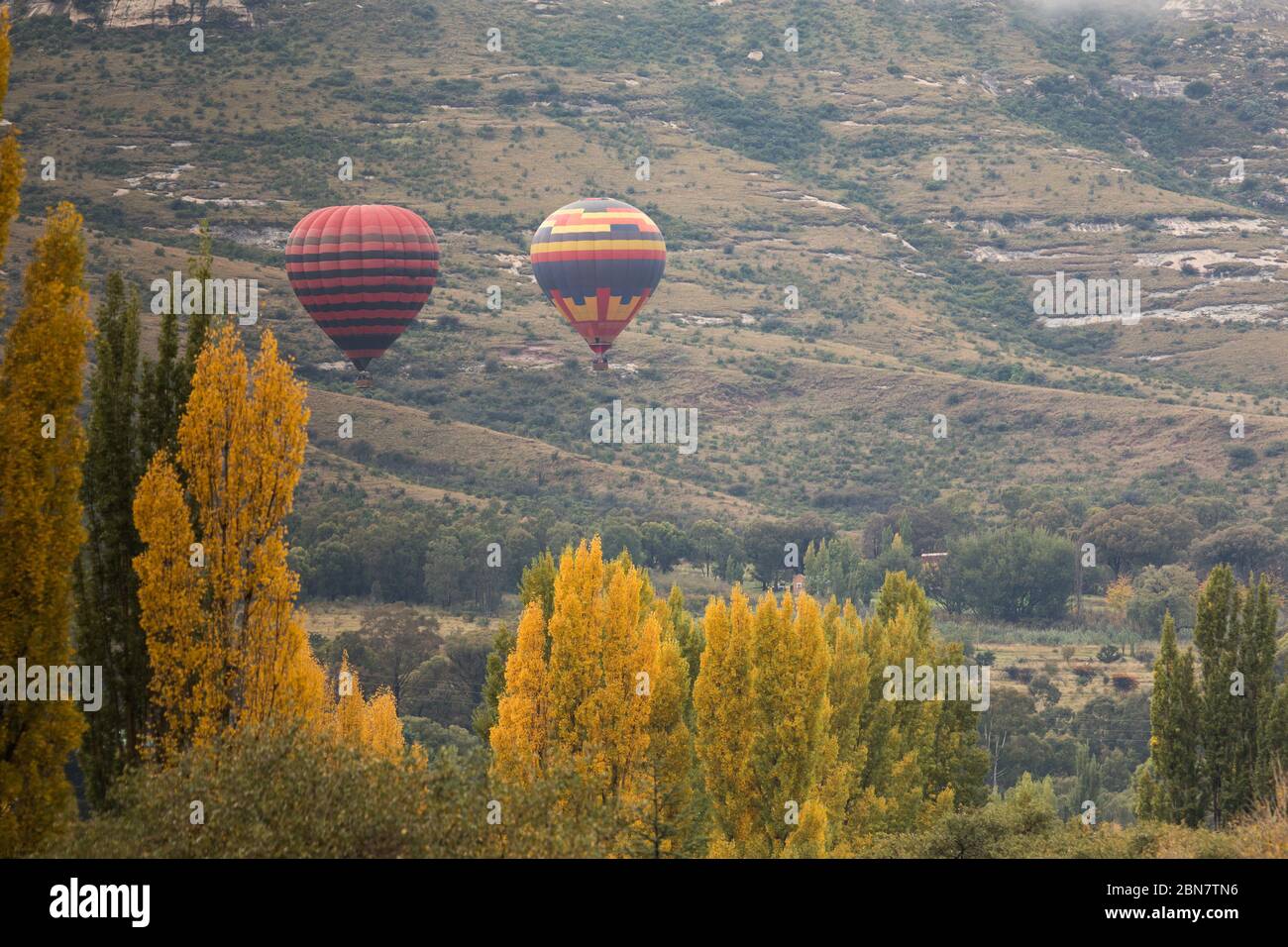 Clarens, Free State, South Africa is a tourist town of beautiful mountain scenery and a variety of tourist activities including hot air ballooning. Stock Photo