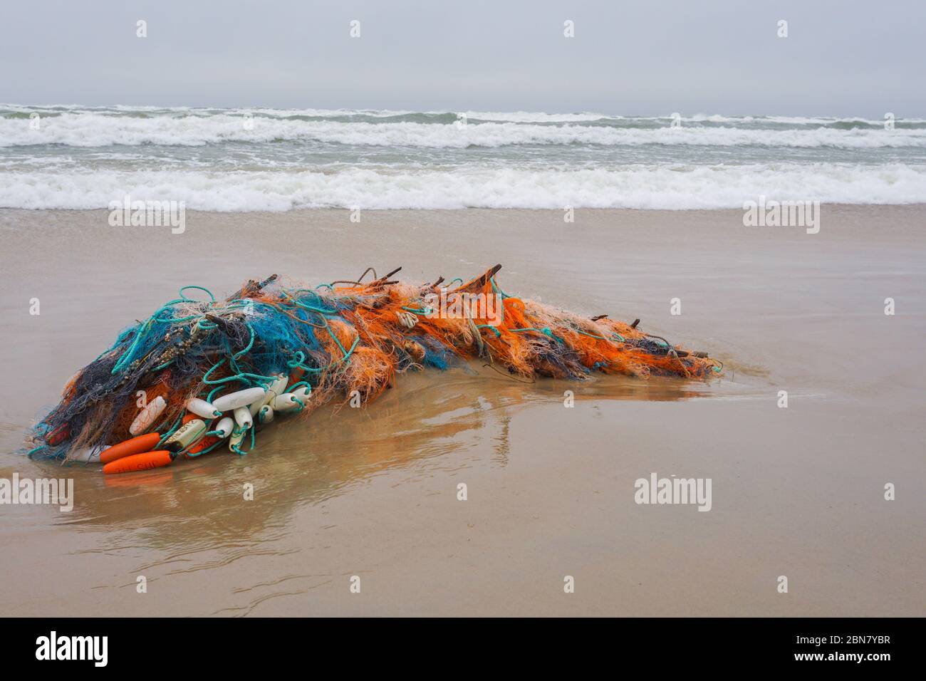 Fishing nets on a sand after sea storm. Garbage in the nature