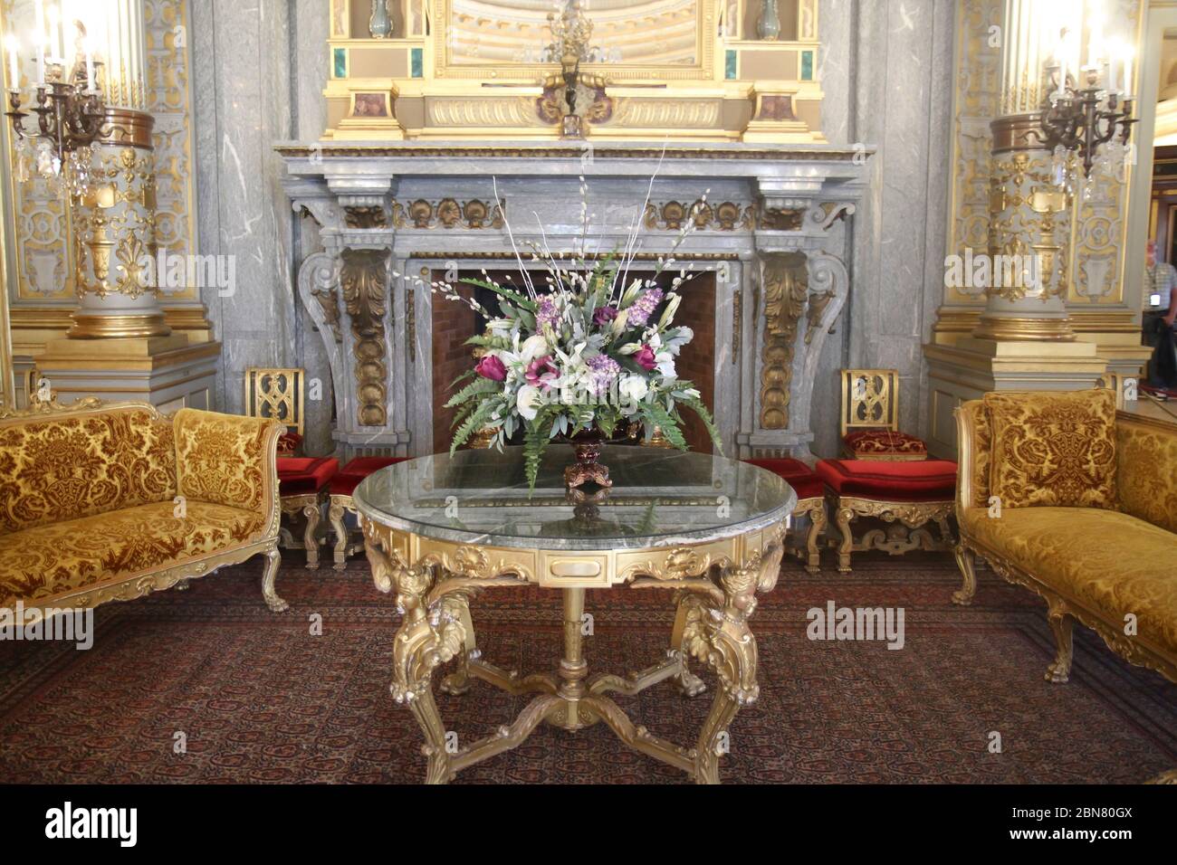 Floral centerpiece amidst the opulent decor inside the Breakers mansion, Newport, Rhode Island, United States Stock Photo