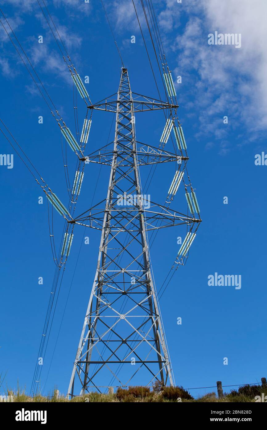 A transmission tower or power tower (alternatively electricity pylon or variations) is a tall structure, usually a steel lattice tower, used to suppor Stock Photo