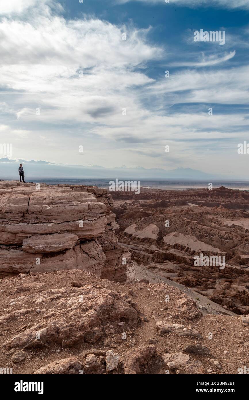 single person looks out at the view over the Valley of the Moon from Mirador de Kari, Piedra del Coyote , San Pedro de Atacama, Antofagusta, Chile Stock Photo