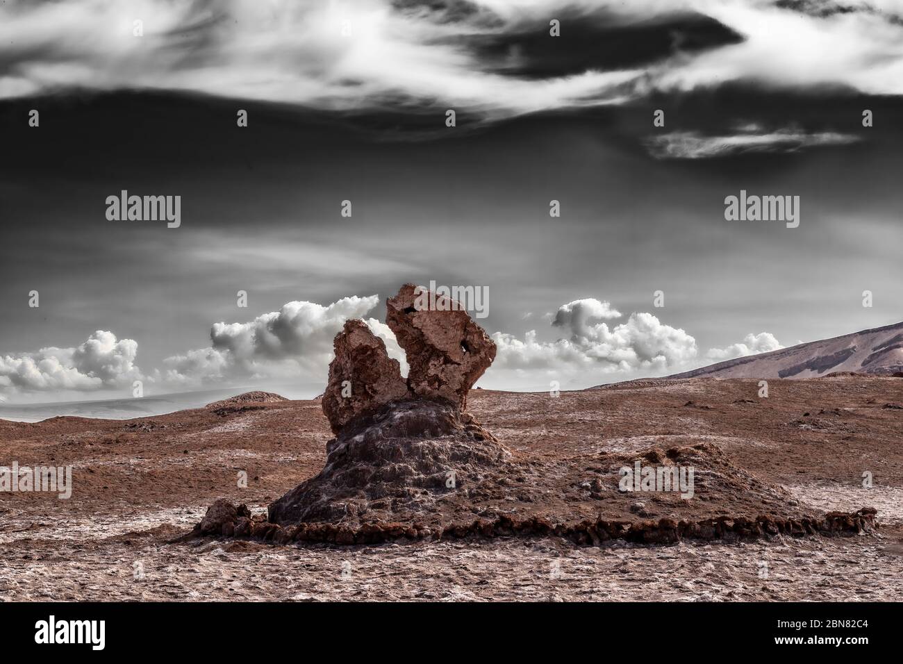 Partially black and white digitally manipulated image of the Tres marias, stone formations eroded by salt and desert wind.  San Pedro de Atacama Stock Photo