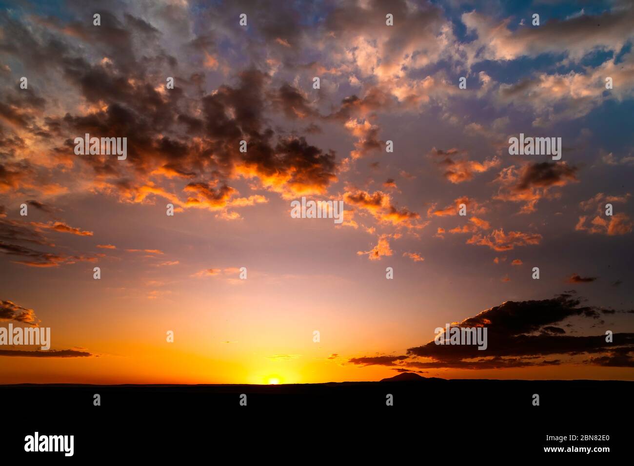 Sunset seen from the western side of Laguna Tebinquiche, San Pedro de Atacama.  Looking west towards Cerro Quimal and the Chilean Coastal Range. Stock Photo