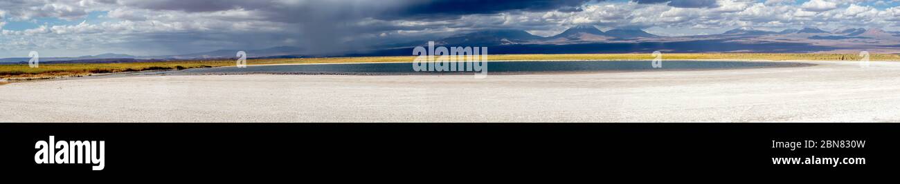 Views over the Laguna Piedra and salt flats towards the mountains and Juriques volcano.  San Pedro de Atacama, Antofagasta, Chile Stock Photo