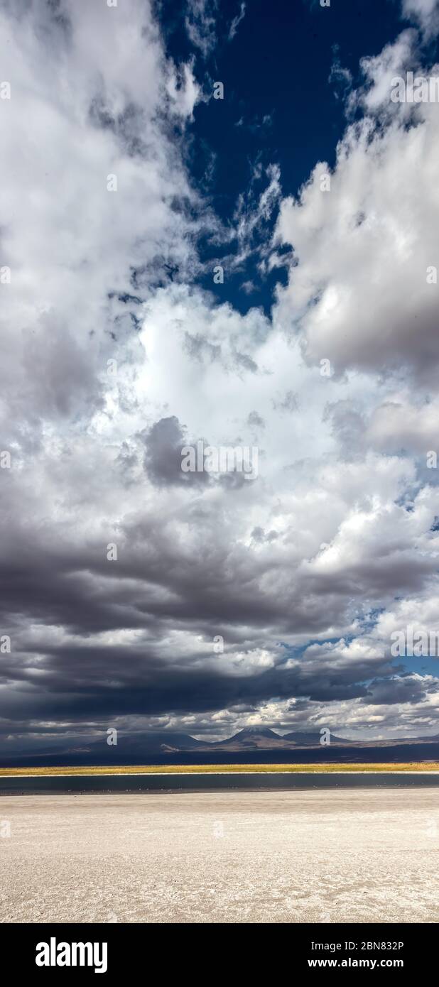 Views over the Laguna Piedra and salt flats towards the mountains and Juriques and Licancabur volcanoes.  San Pedro de Atacama, Antofagasta, Chile Stock Photo