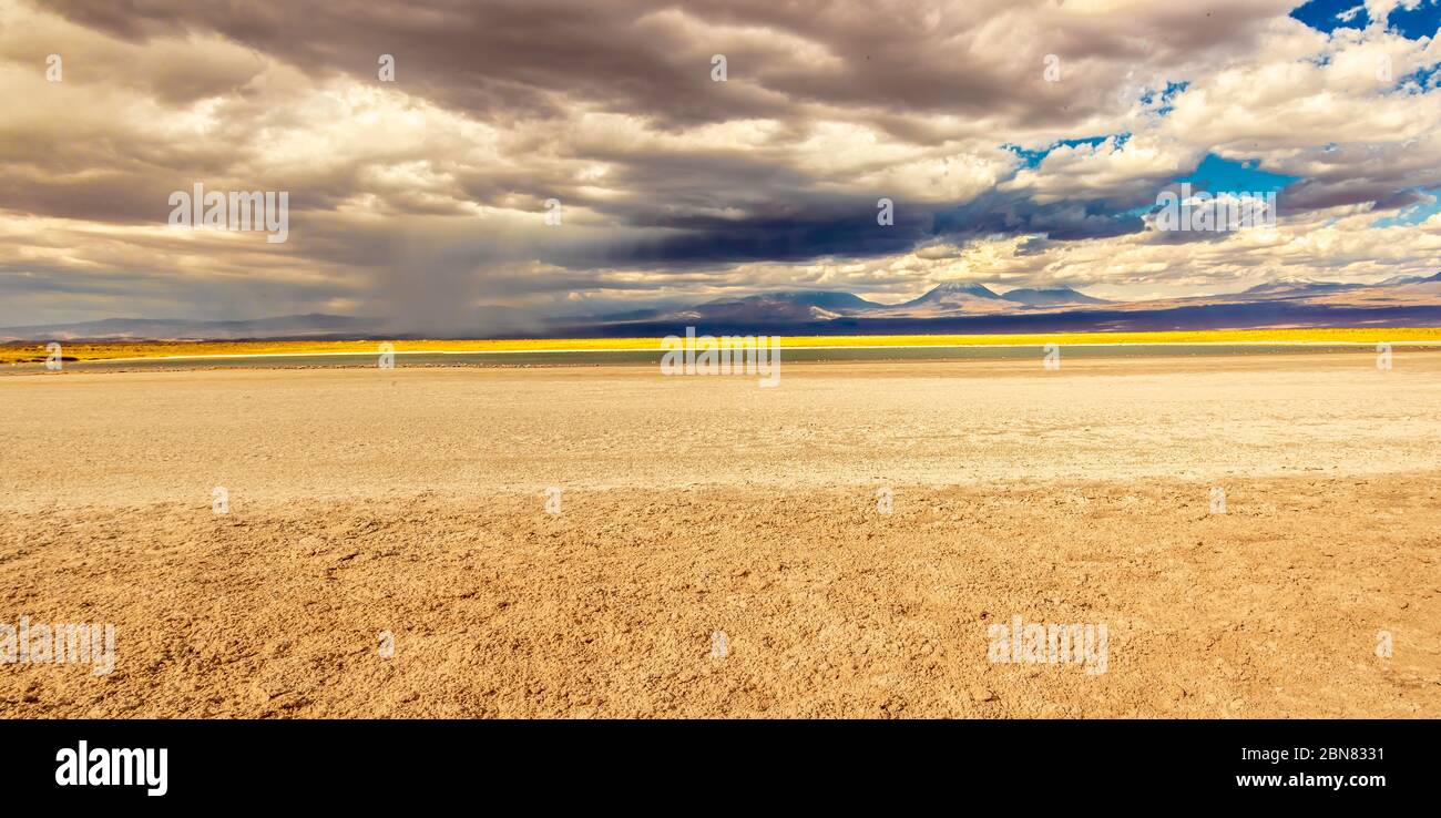 Views over the Laguna Piedra and salt flats towards the mountains and Juriques volcano.  San Pedro de Atacama, Antofagasta, Chile Stock Photo